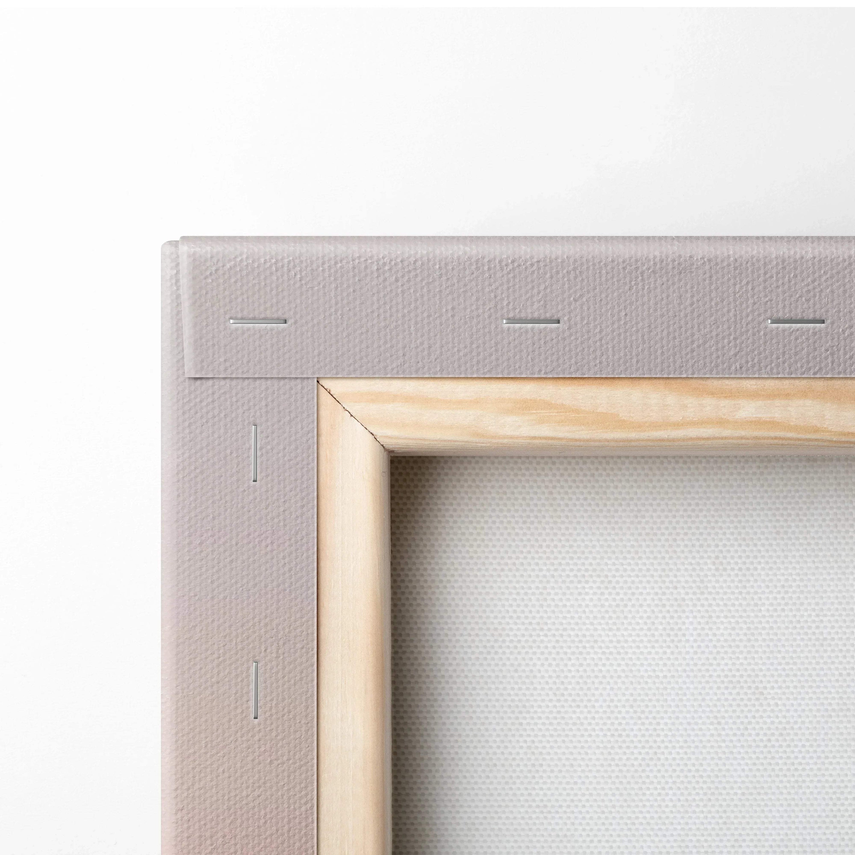 Close-up of wooden frame corner and stretched canvas texture on wall art panel.