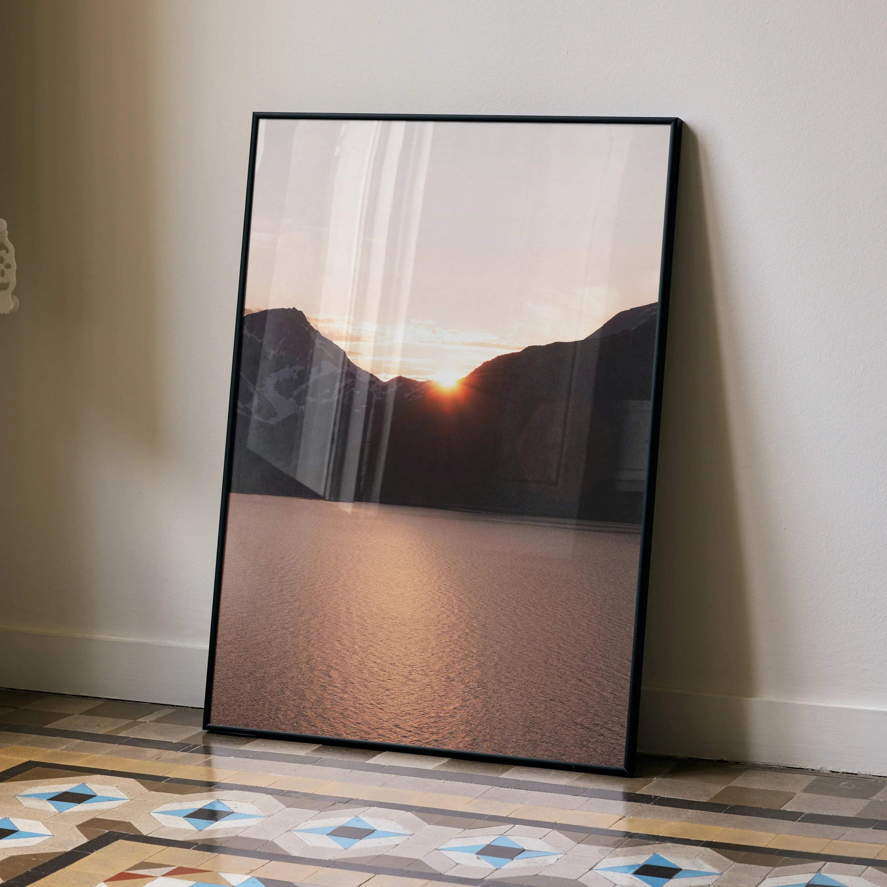 Sunset mountains poster wall art with glowing sun over lake in vertical frame.