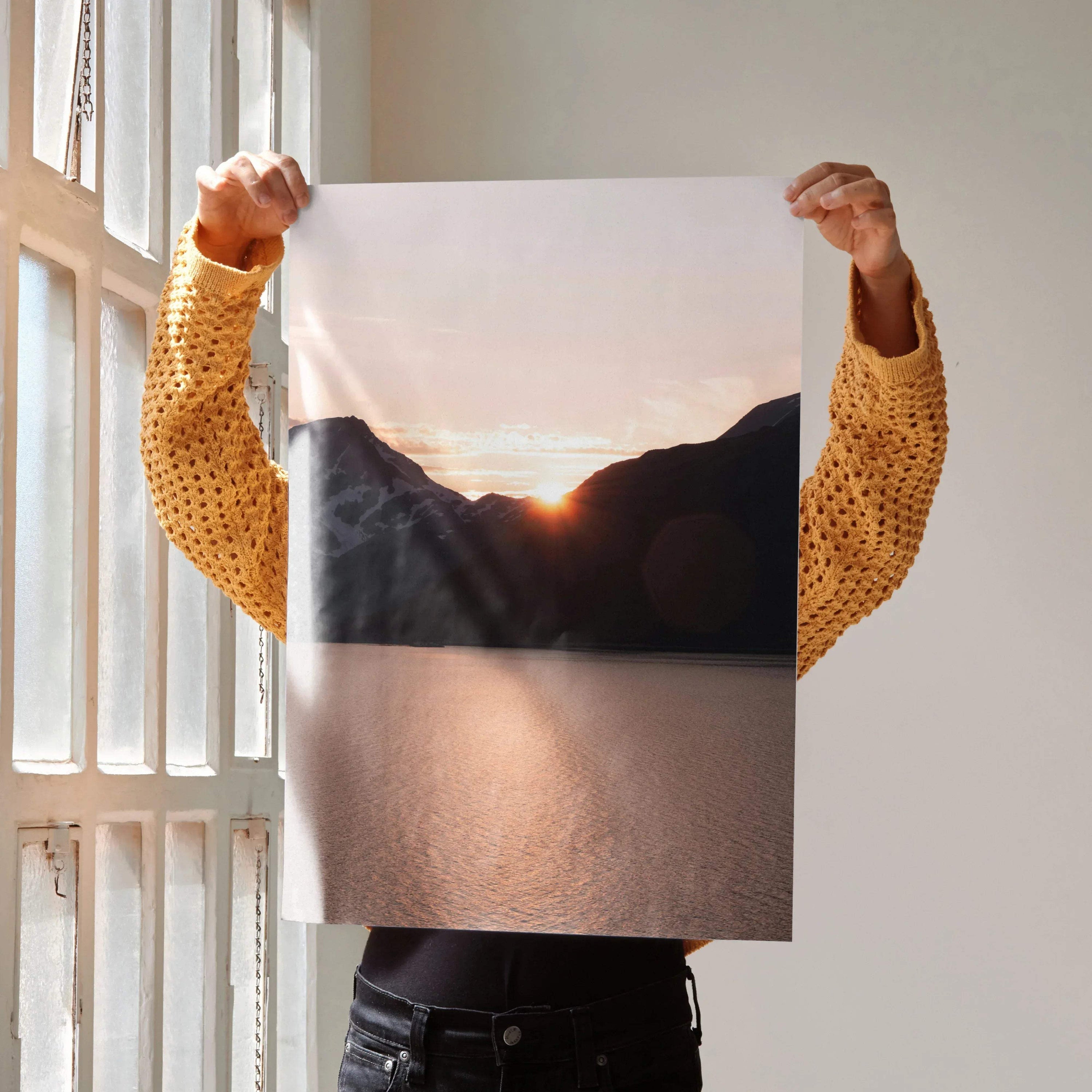 Sunset mountains poster with glowing sun and reflective water, vertical wall art print.