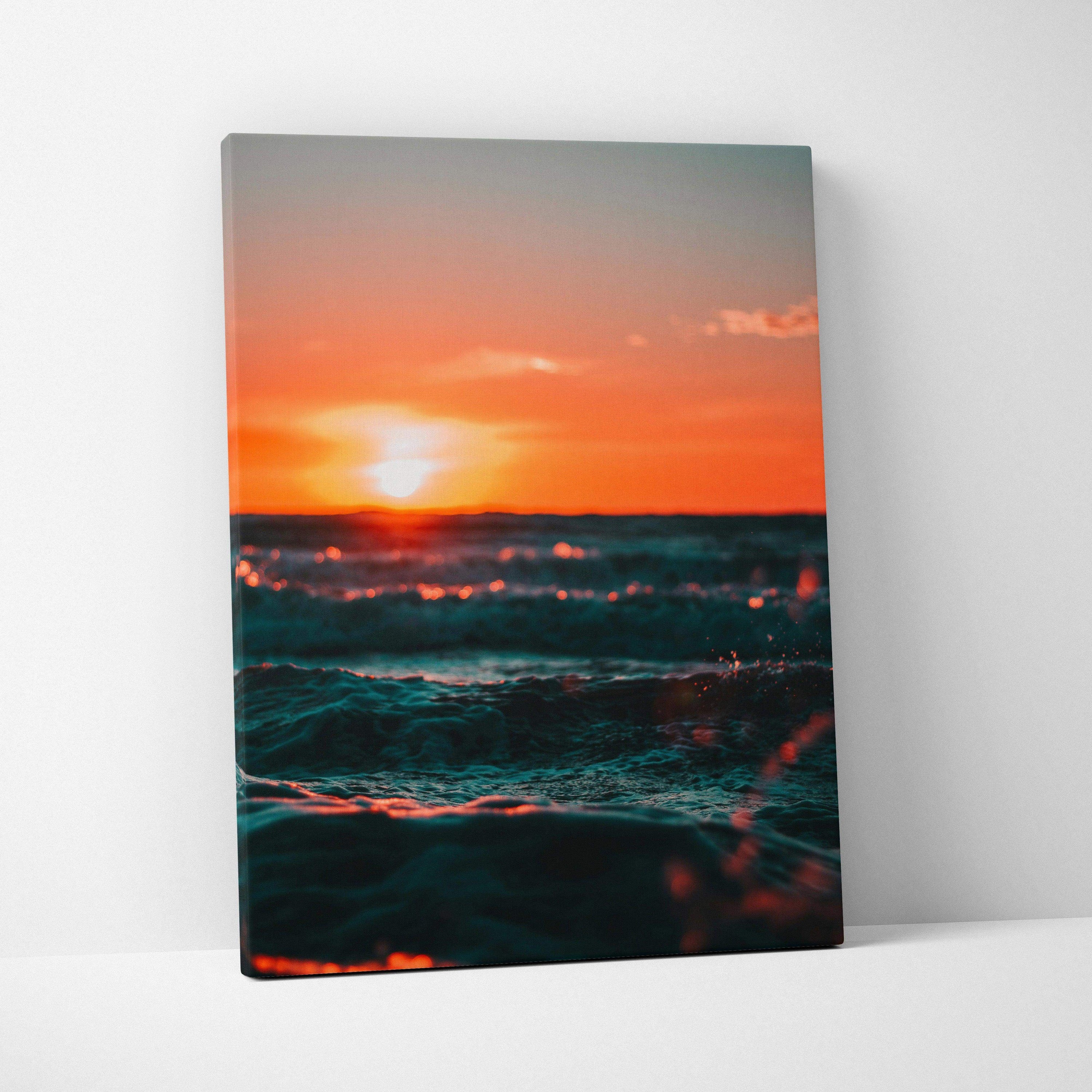 Sunset over ocean waves vibrant canvas wall art with warm orange and teal tones.