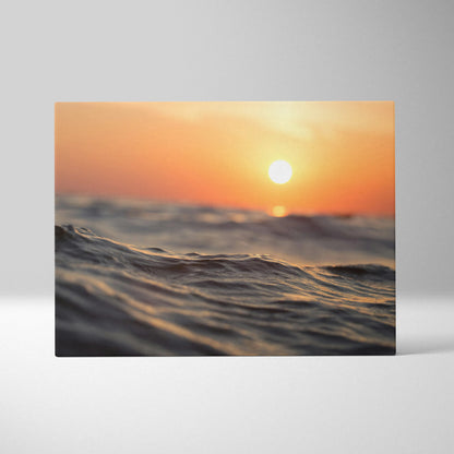Sunset ocean scene with glowing sun over gentle waves, canvas wall art print with warm tones.