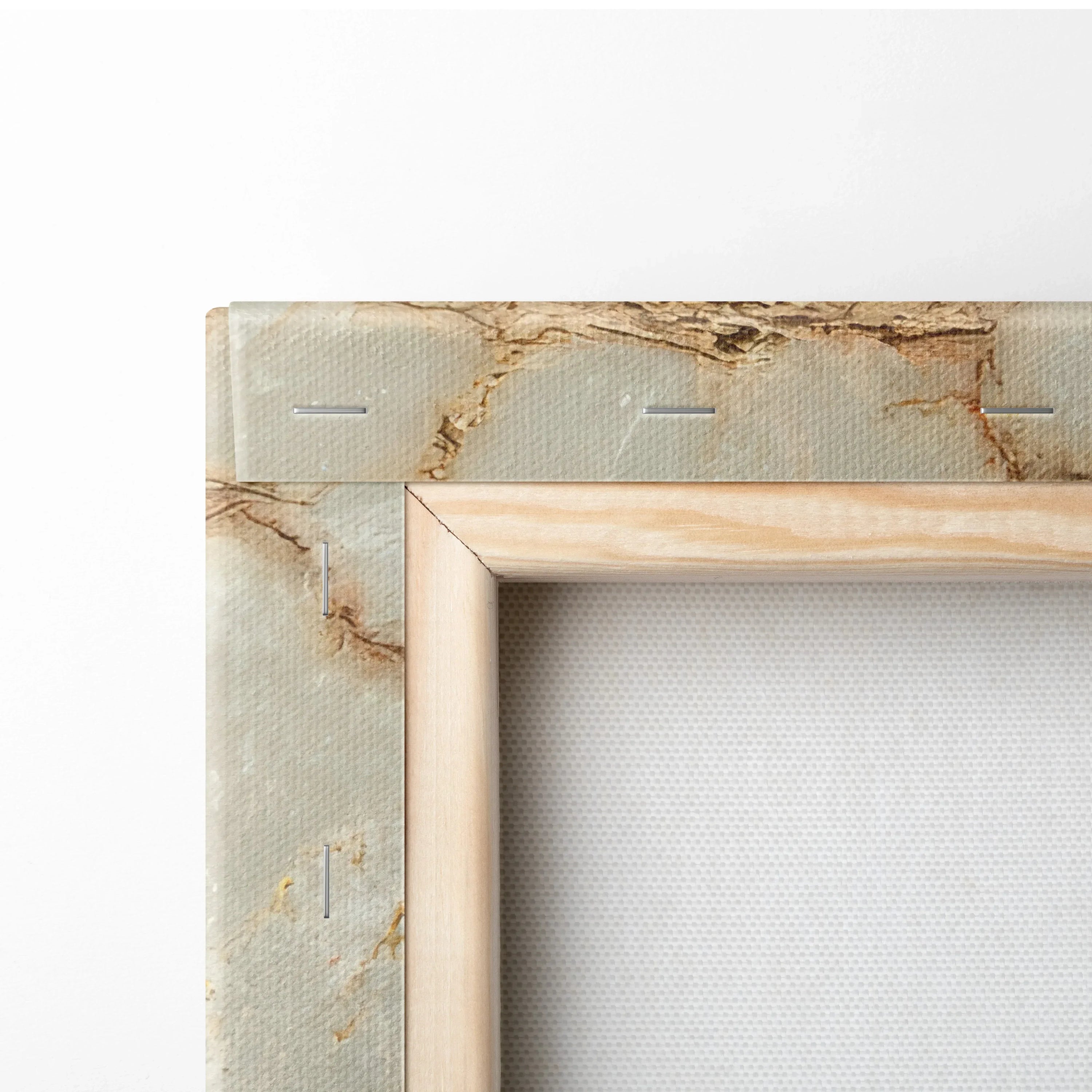 Corner close-up of canvas wall art showing beige abstract texture with wooden stretcher bars and staples.