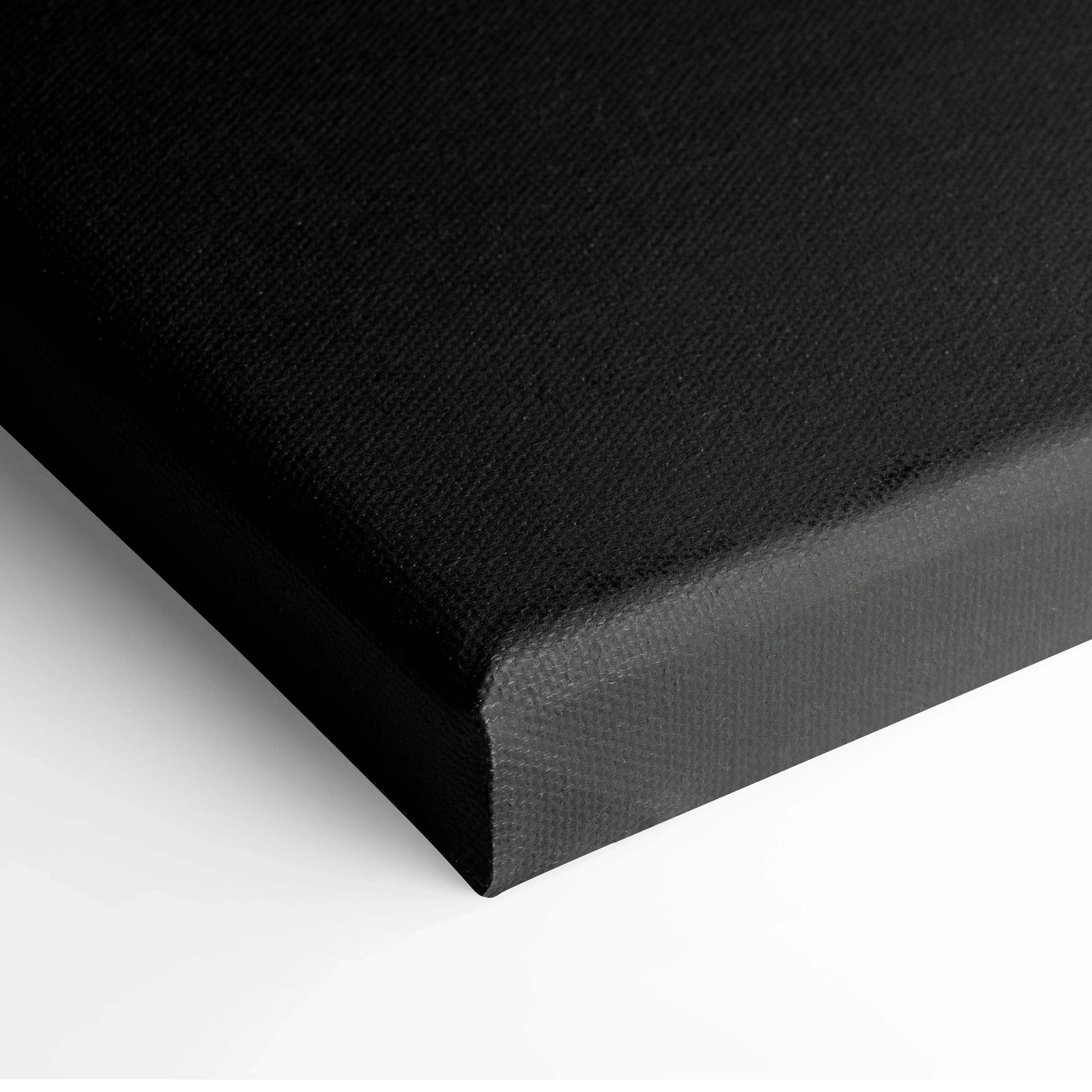 Black stretched canvas corner showing texture and cleanly wrapped edge for wall art.