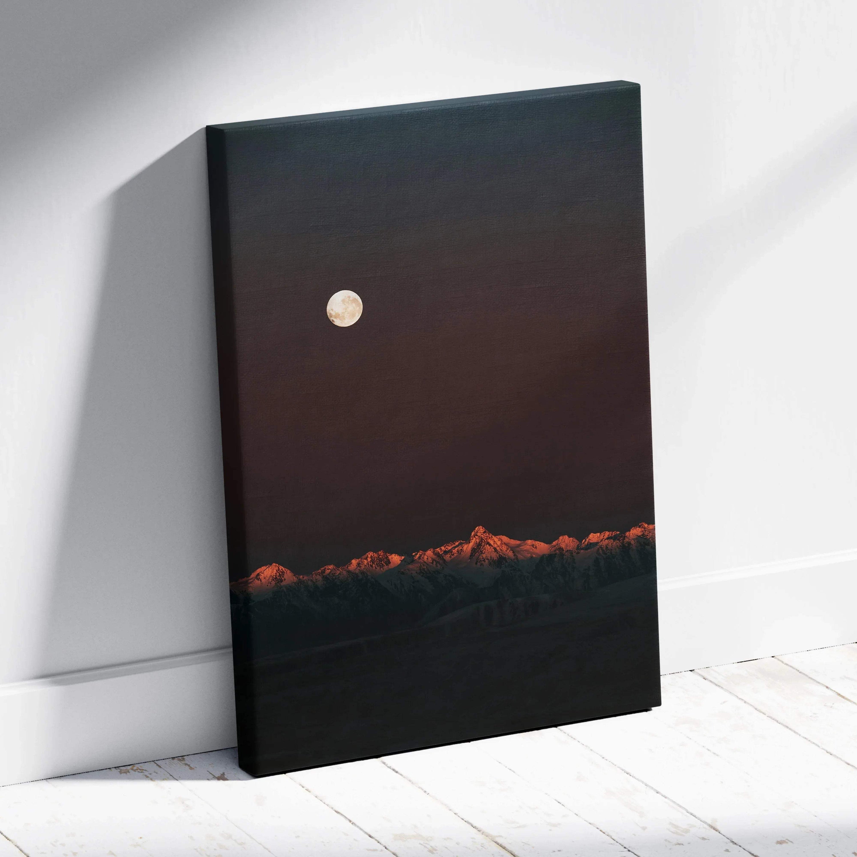 Vertical canvas wall art featuring a dark mountain landscape with glowing moon and orange-tipped peaks.