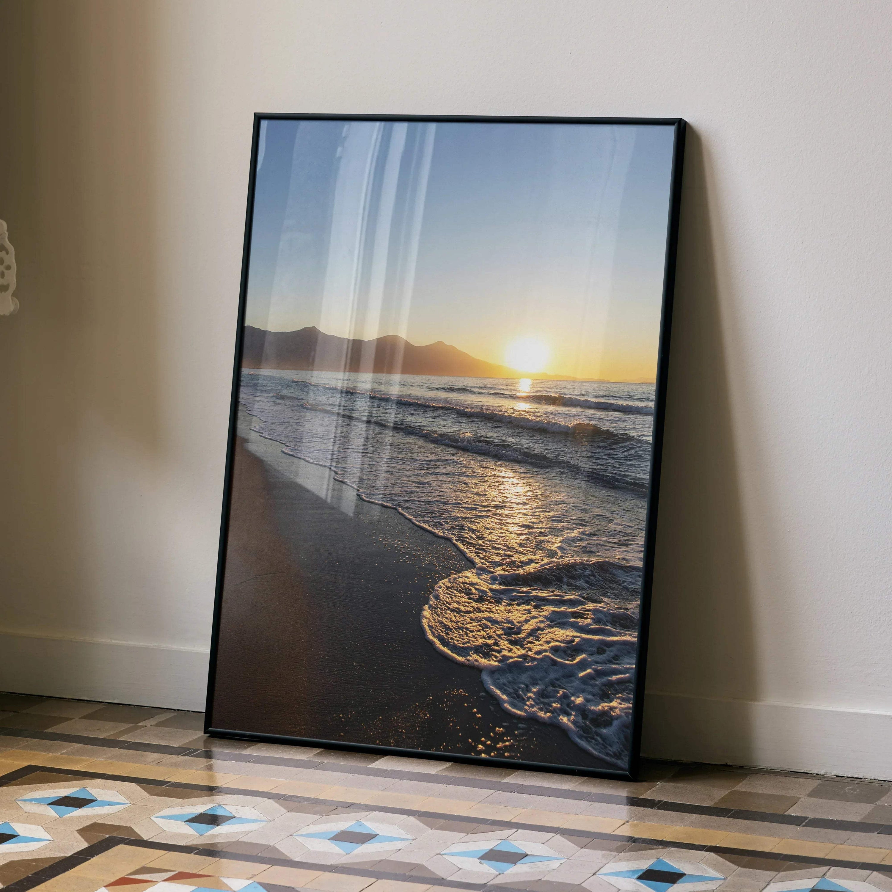 Beach sunset poster wall art with waves and sun over distant mountains in vertical format.