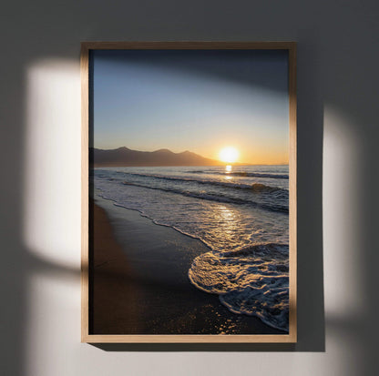 Beach sunset poster wall art with golden sun, waves, and sandy shore in vertical frame.