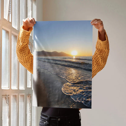 Beach sunset poster wall art with golden sun reflecting on ocean waves and shoreline.