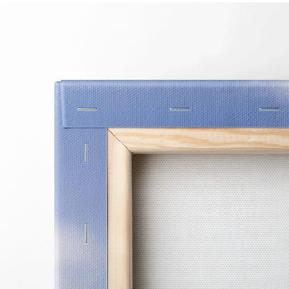 Close-up of wooden stretcher frame with blue canvas wrapped and stapled, showing texture of wall art canvas.