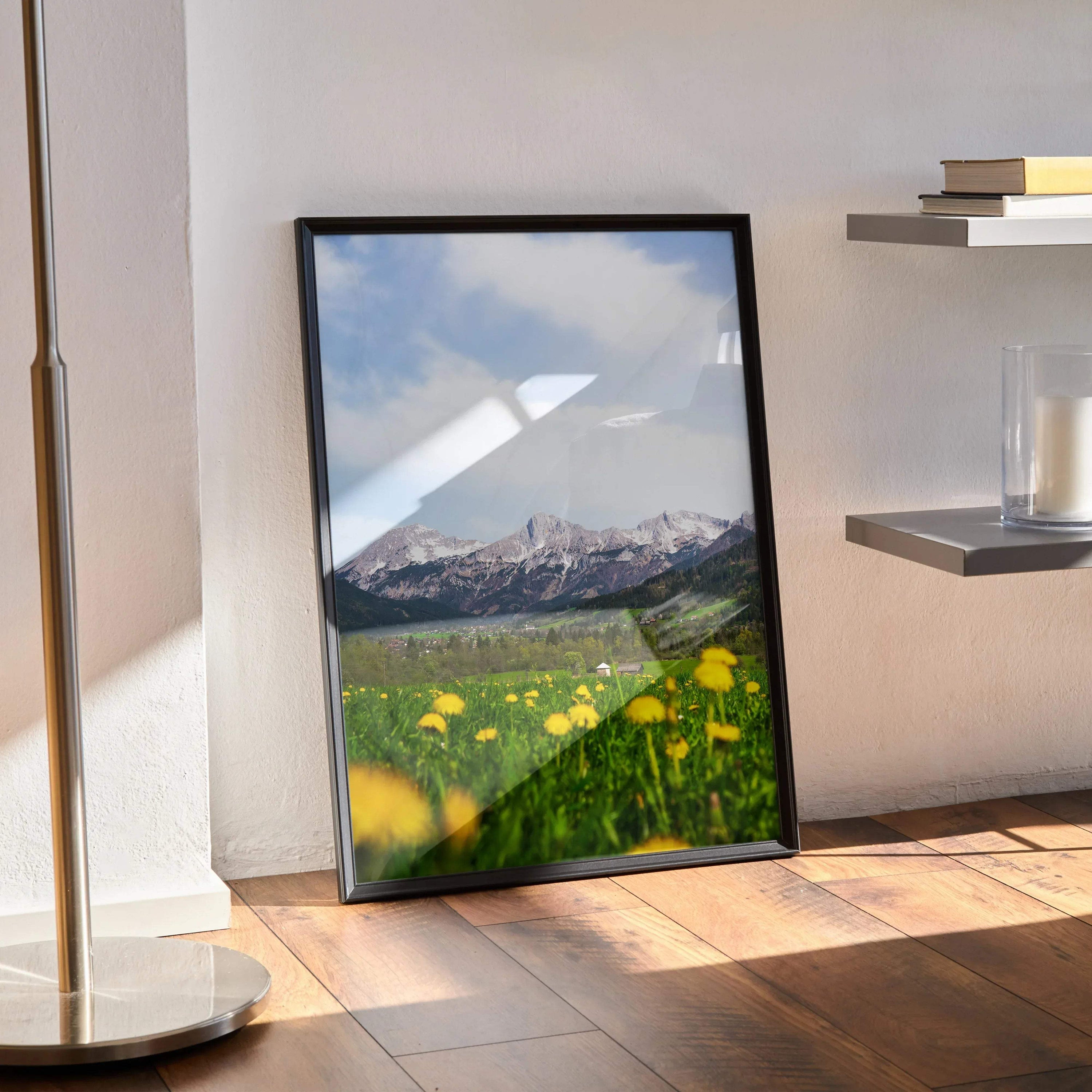 Vertical poster wall art featuring majestic snow-capped mountains and a green meadow with yellow flowers.