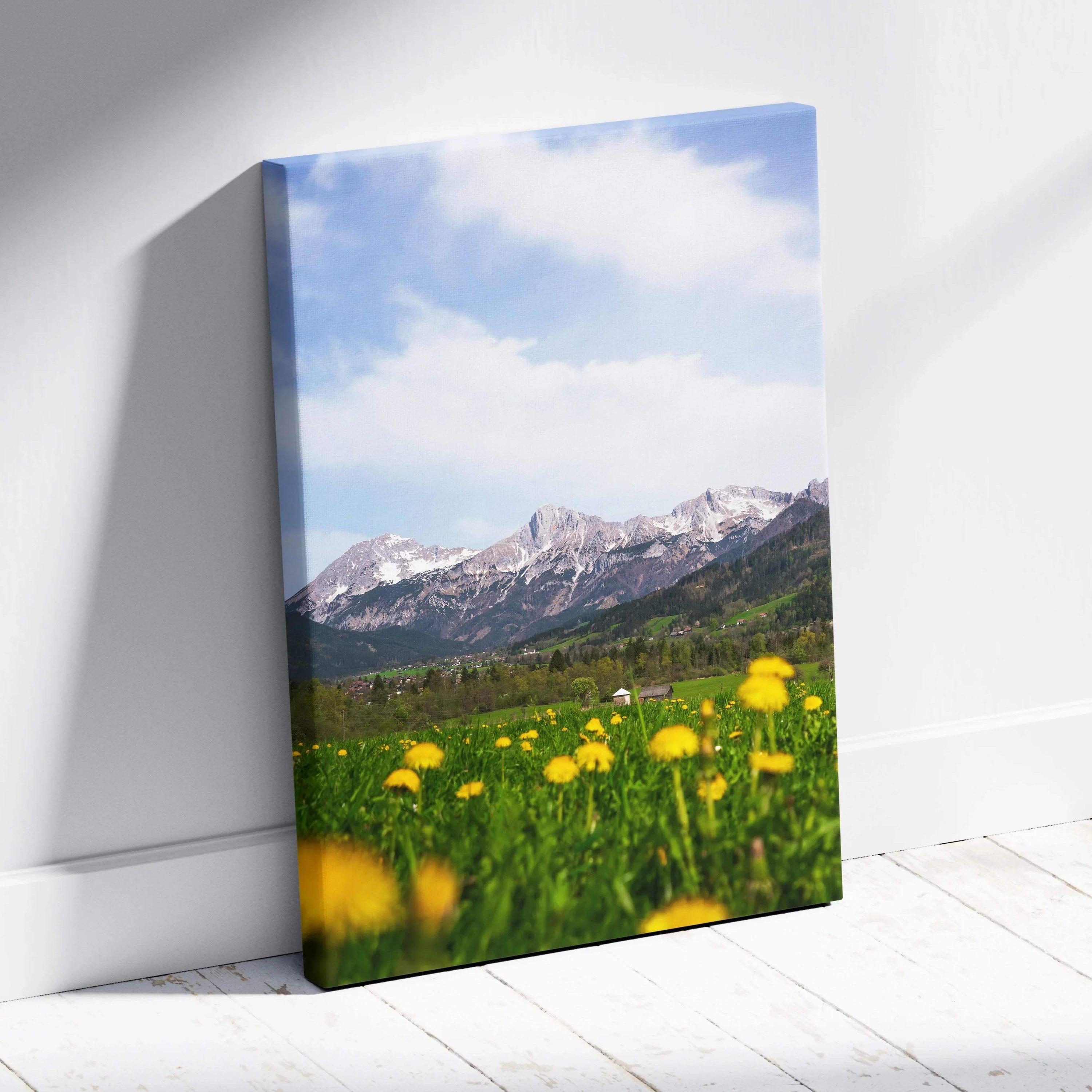Canvas wall art featuring a bright mountain scene with a green meadow and yellow wildflowers under a blue sky.
