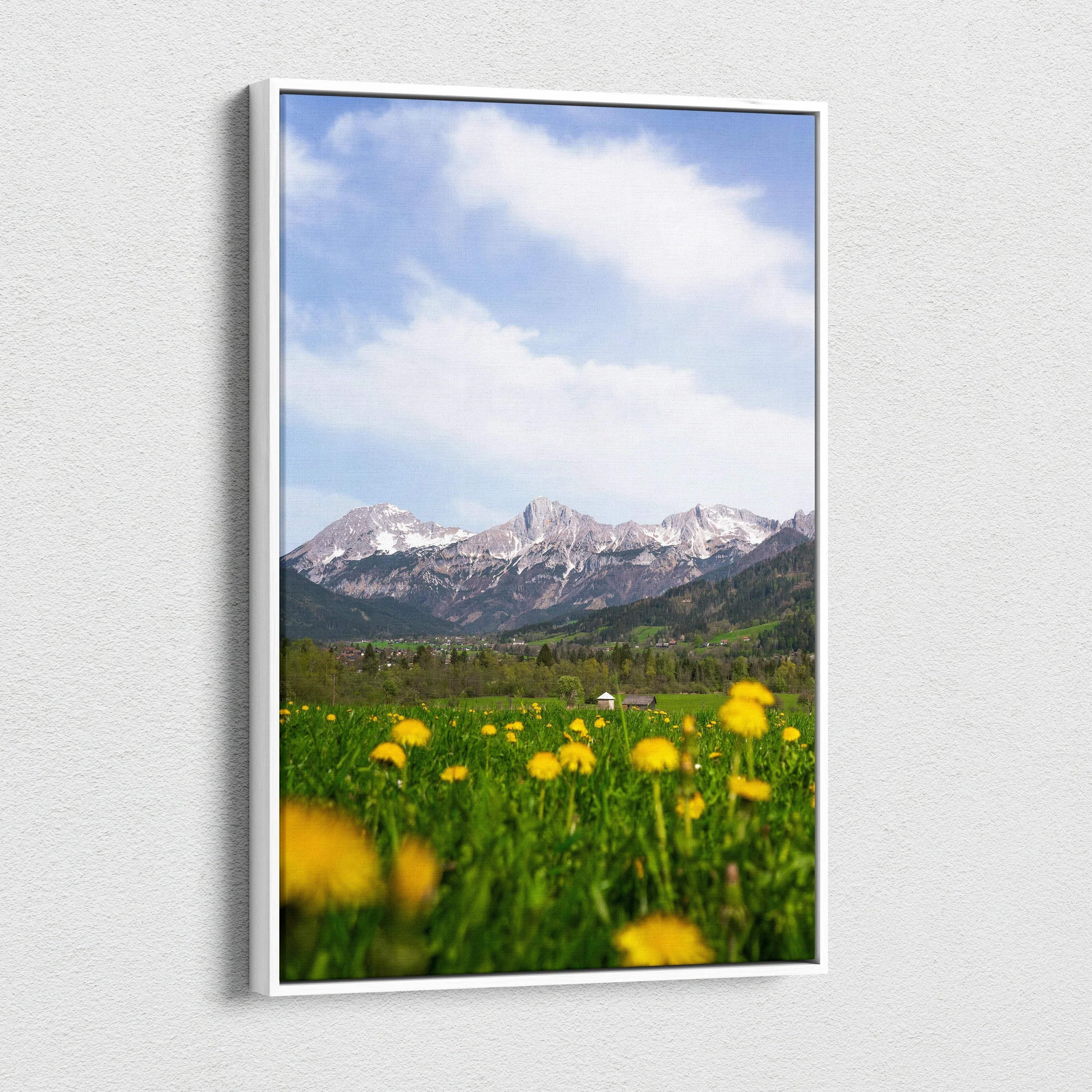 Canvas wall art featuring a mountain landscape with a blue sky and yellow wildflowers in the foreground.