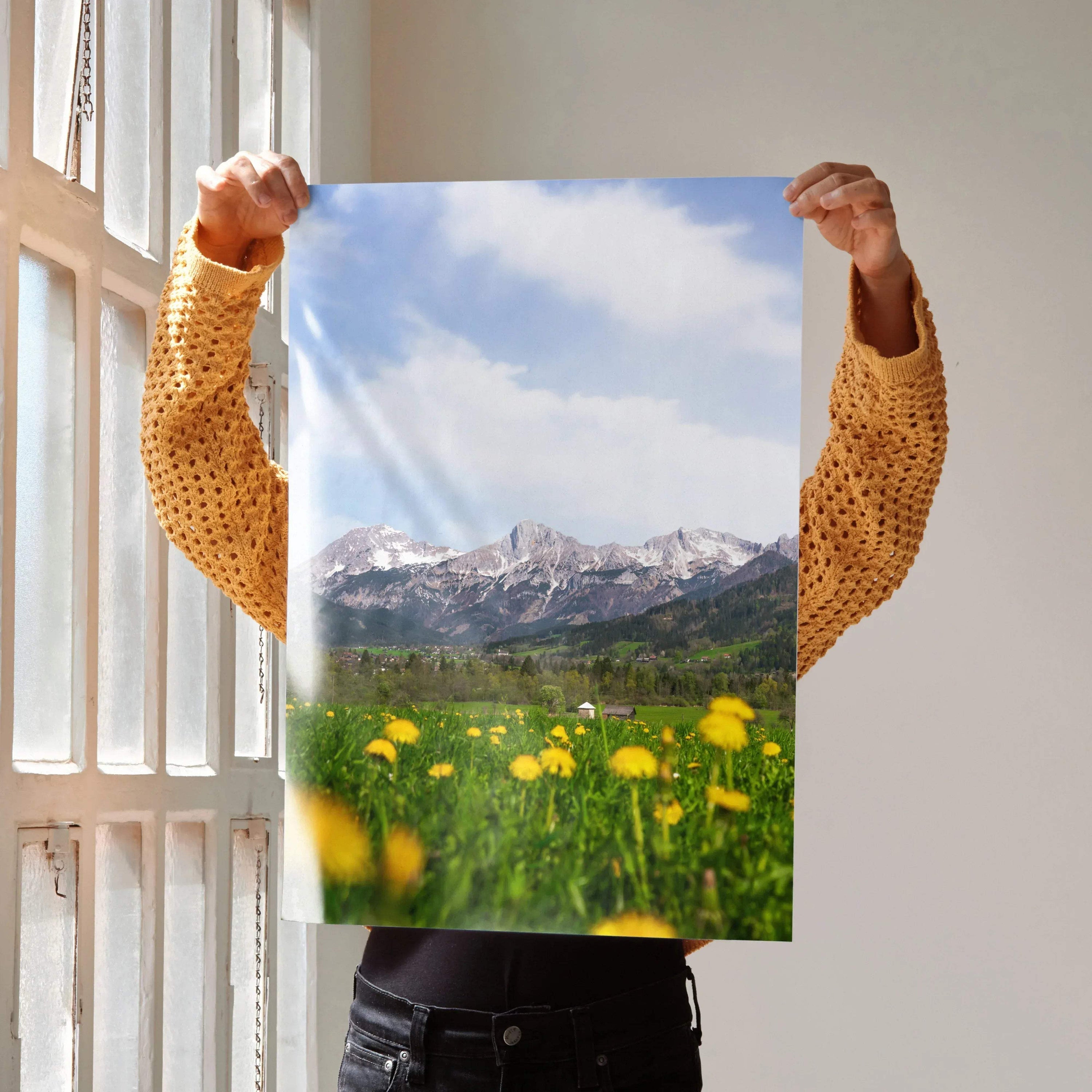 Vertical wall art poster featuring majestic snow-capped mountains with a green meadow and yellow flowers under a blue sky.