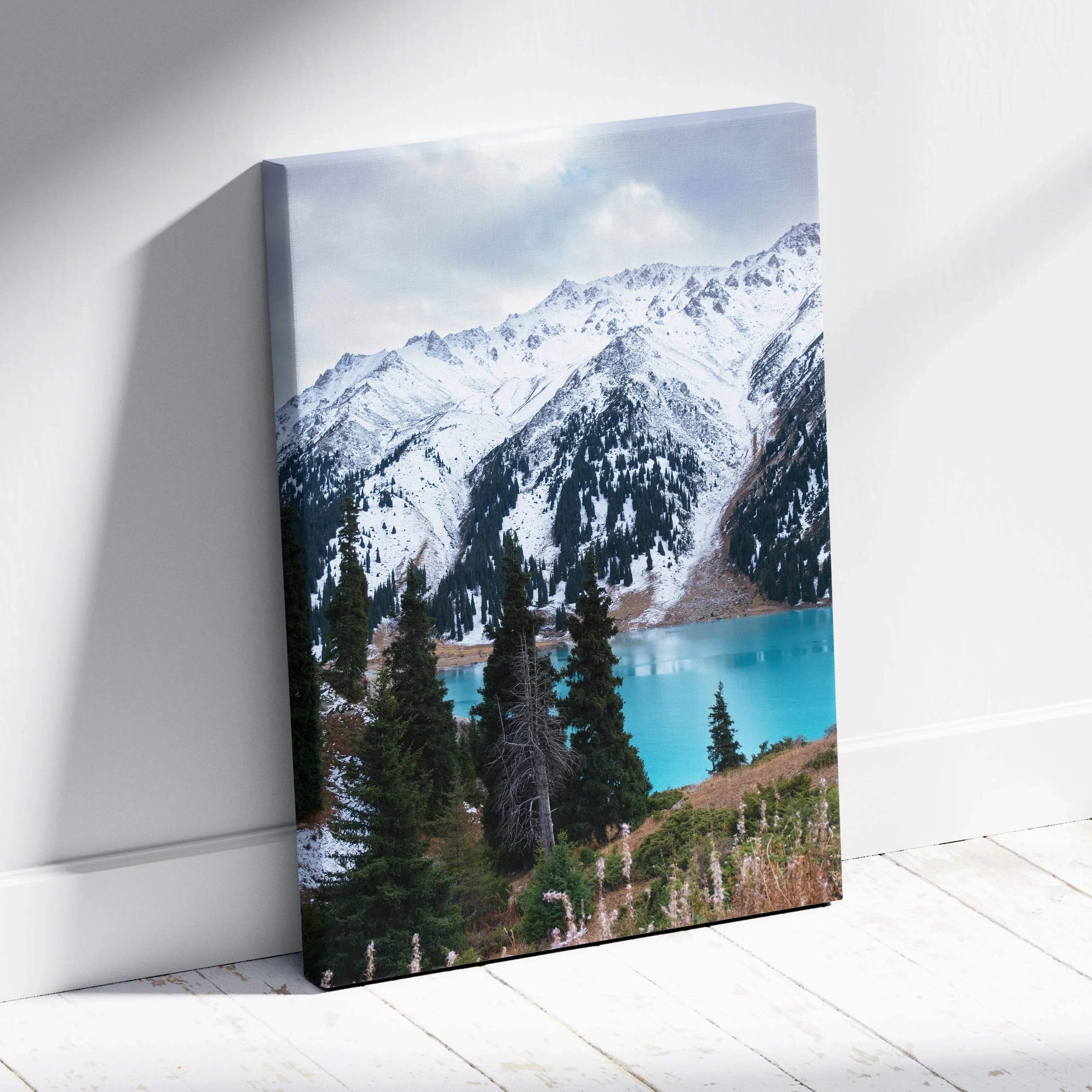 Canvas wall art featuring stunning snow-capped mountains above a turquoise lake with pine trees.
