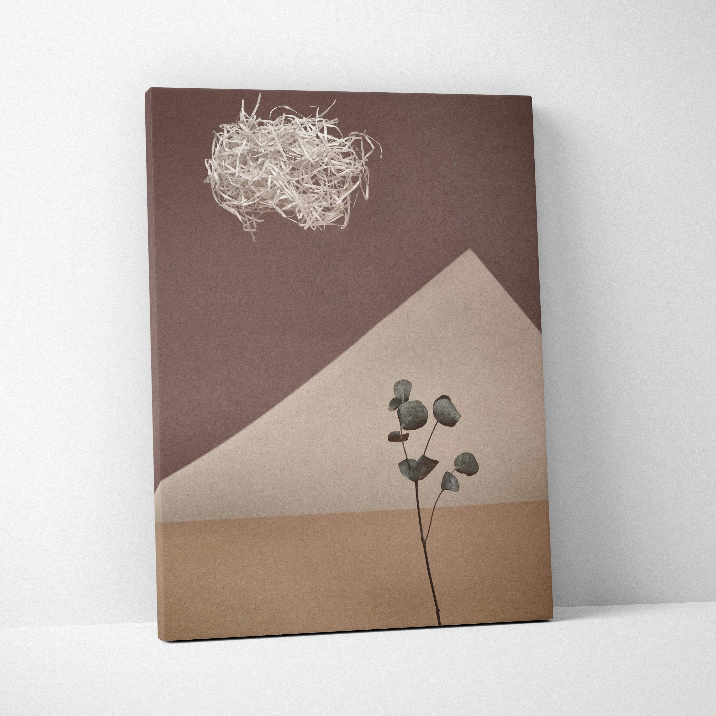 Contemporary neutral botanical canvas wall art with a eucalyptus branch on brown and beige geometric panels