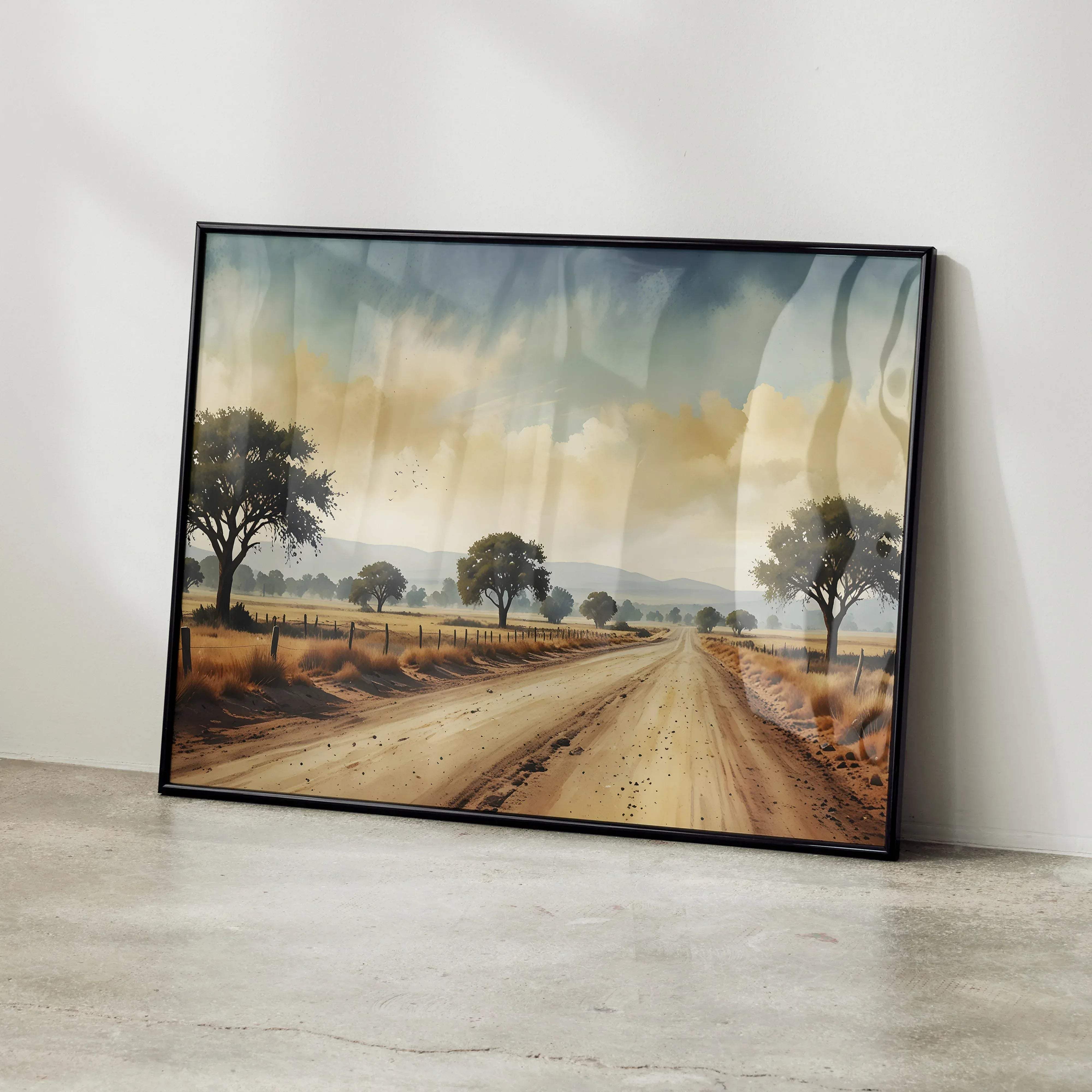 A framed vibrant watercolor styled nature art print poster of a dirt road with trees under a dramatic sky in black frame
