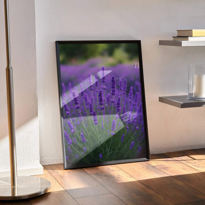 Vibrant floral digital art poster with purple lavender-like flowers in black frame leaning on wall.