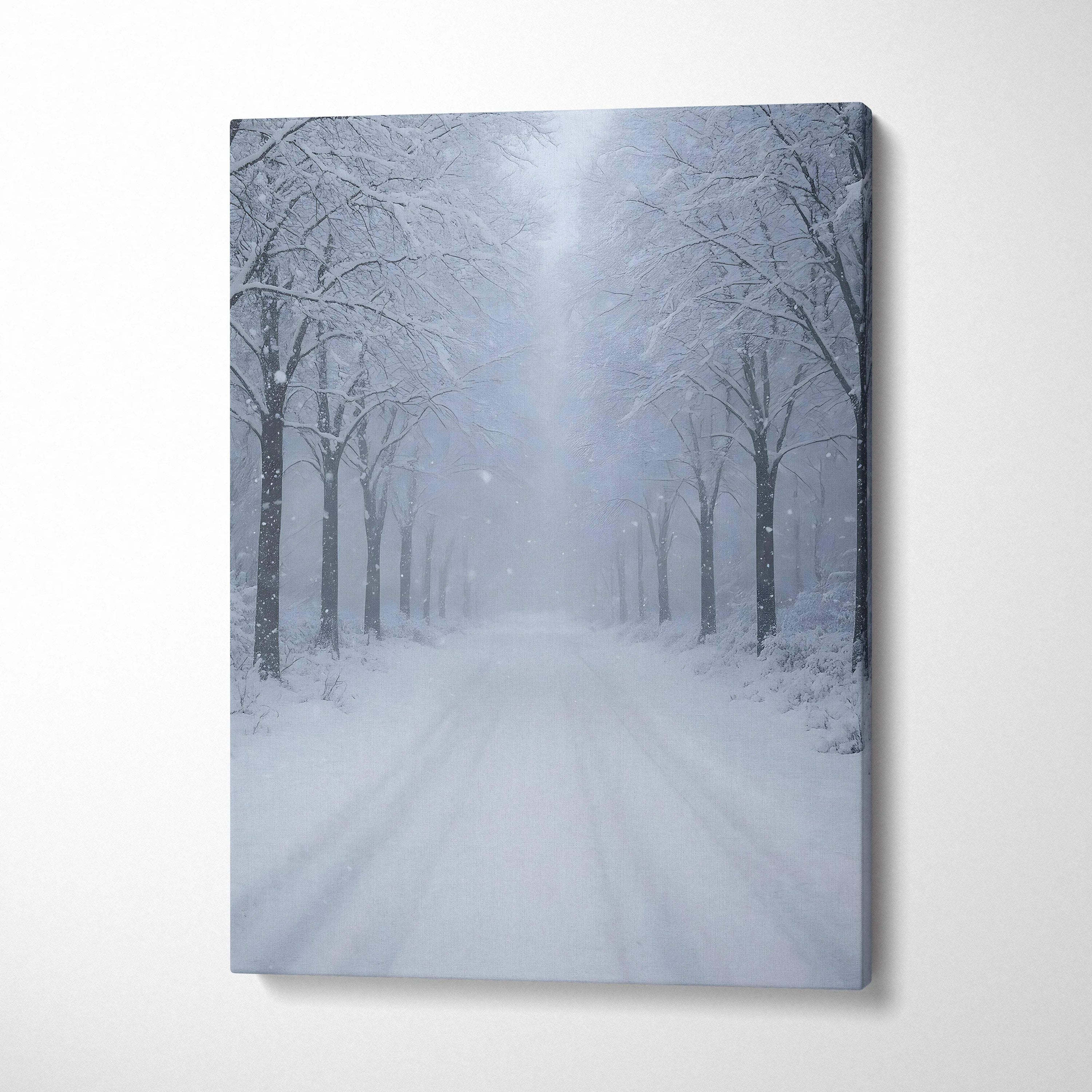 Canvas wall art of a snowy landscape with frosted trees lining a snow-covered road in soft blue tones.