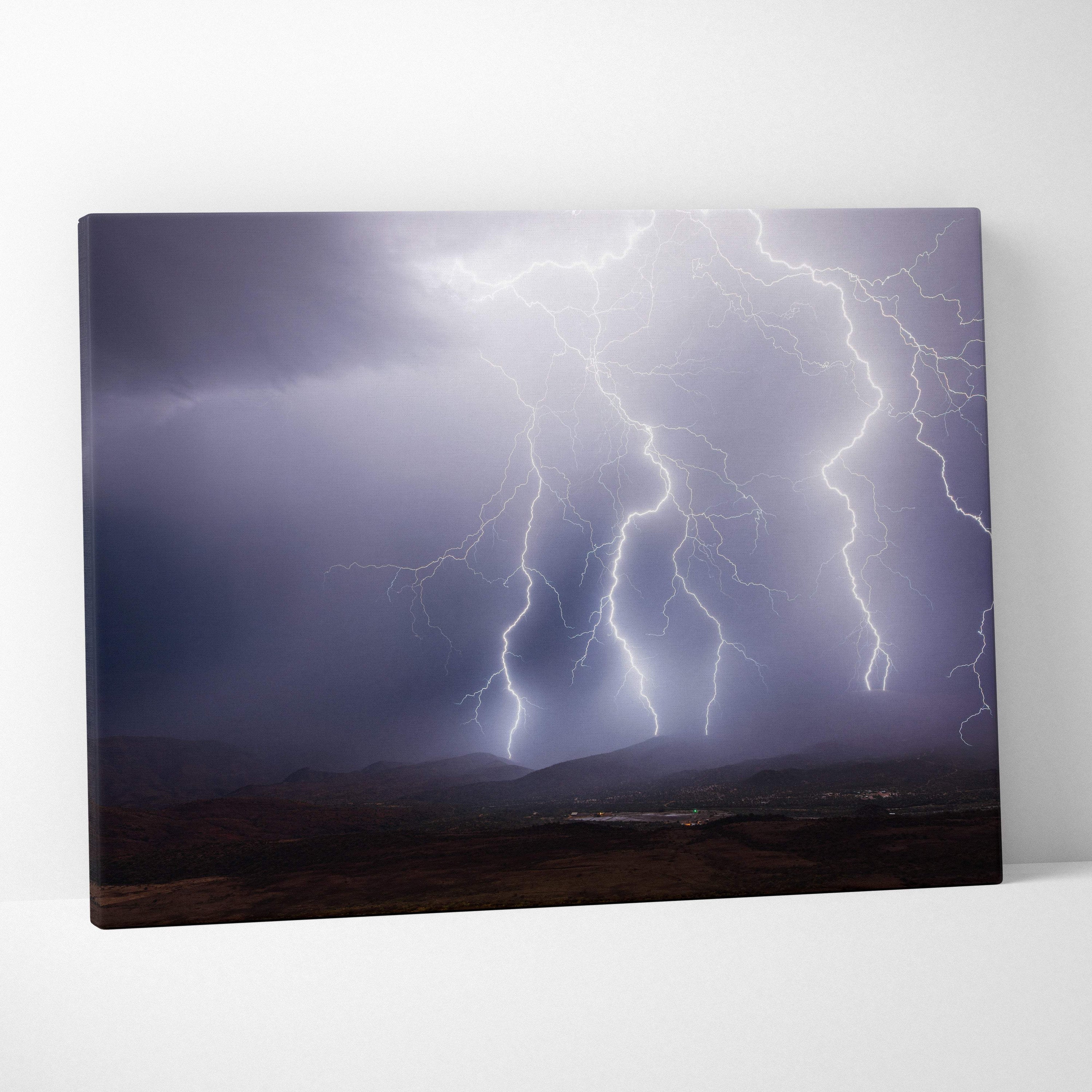 Canvas print of multiple bright white lightning bolts striking over dark moody hills for dramatic wall decor
