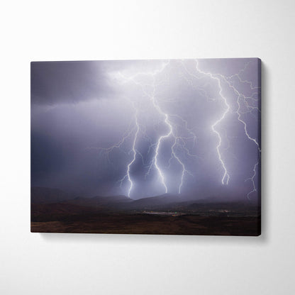 Canvas print of multiple bright white lightning bolts striking through dark moody clouds over a rugged mountain landscape