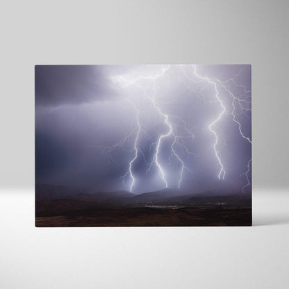 Canvas print of multiple bright white lightning bolts striking over dark moody hills in dramatic mountain landscape