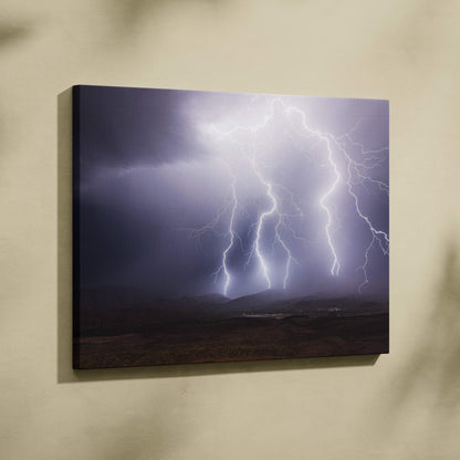 Canvas print of multiple vivid white and purple lightning bolts striking dramatic dark clouds over mountain landscape wall decor