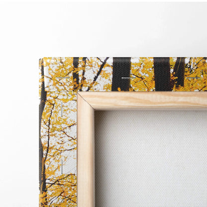 Autumn woodland scene canvas wall art with golden leaves and black tree trunks on wooden frame.