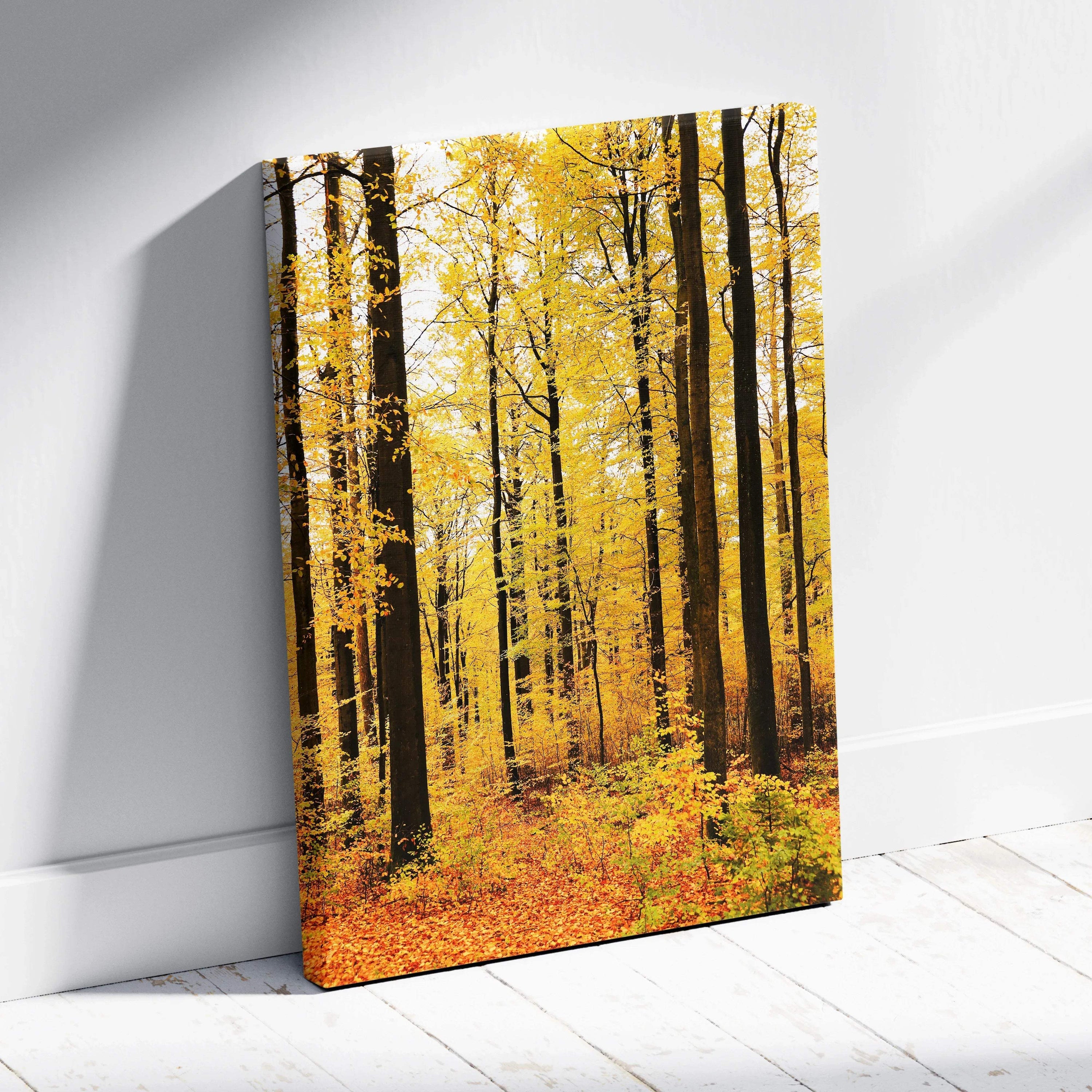 Canvas wall art featuring a vertical autumn woodland scene with golden yellow trees and fallen leaves.