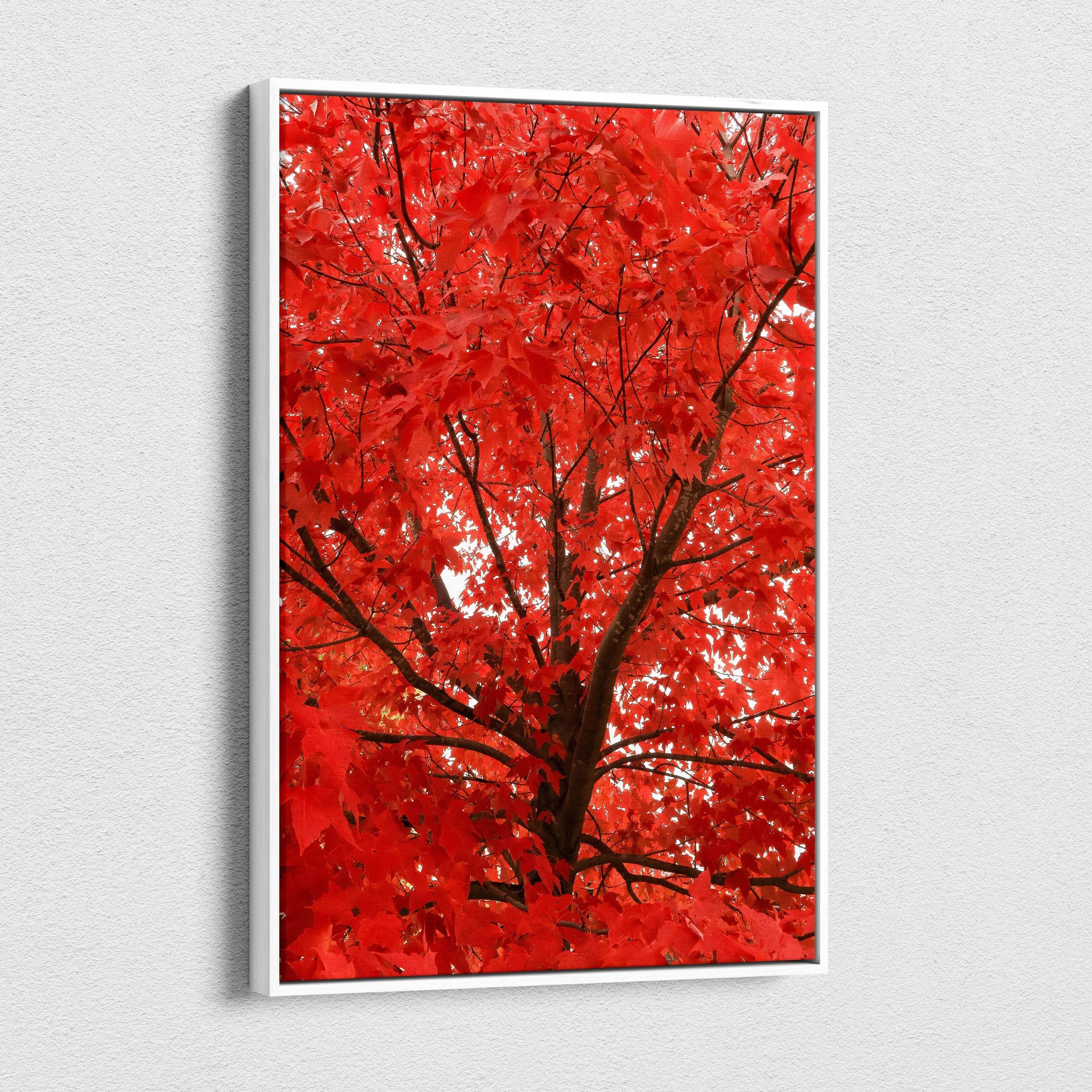 Vertical canvas wall art featuring vibrant red autumn leaves on tree branches.
