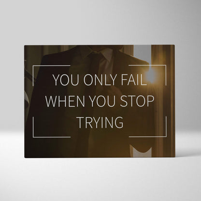 A sleek black rectangular canvas wall art with motivational you only fail when you stop trying quote and minimalist lines