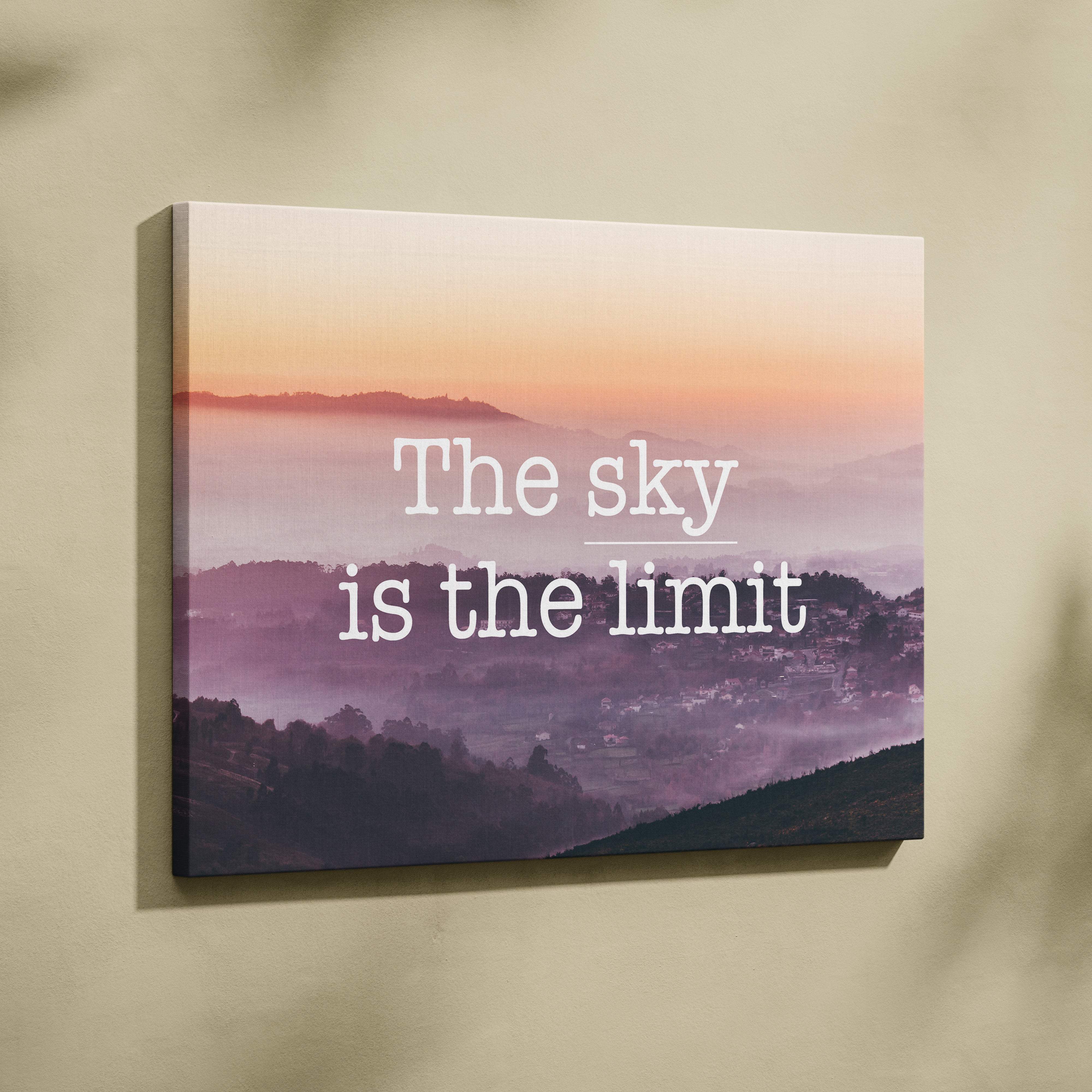 Rectangular canvas print of a pink and purple misty mountain landscape at sunrise with motivational sky is the limit text