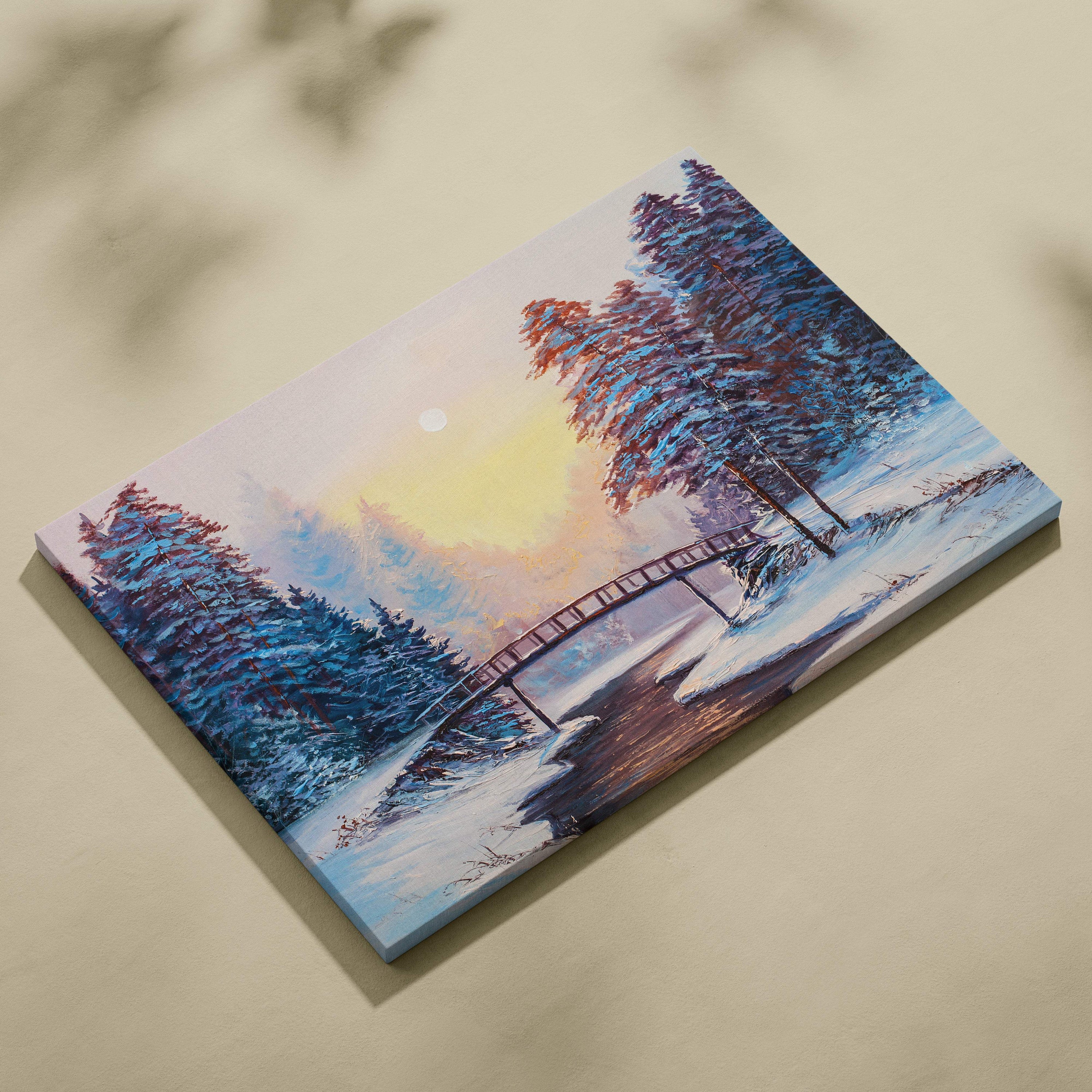Rectangular canvas painting of snowy landscape with pine trees wooden bridge over icy river and warm sunrise glow
