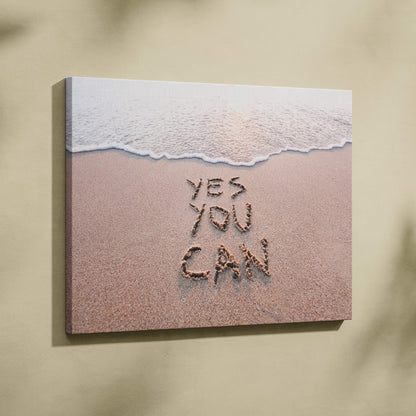 Beige canvas wall art featuring a beach scene with gentle waves and yes you can written in sand inspirational print