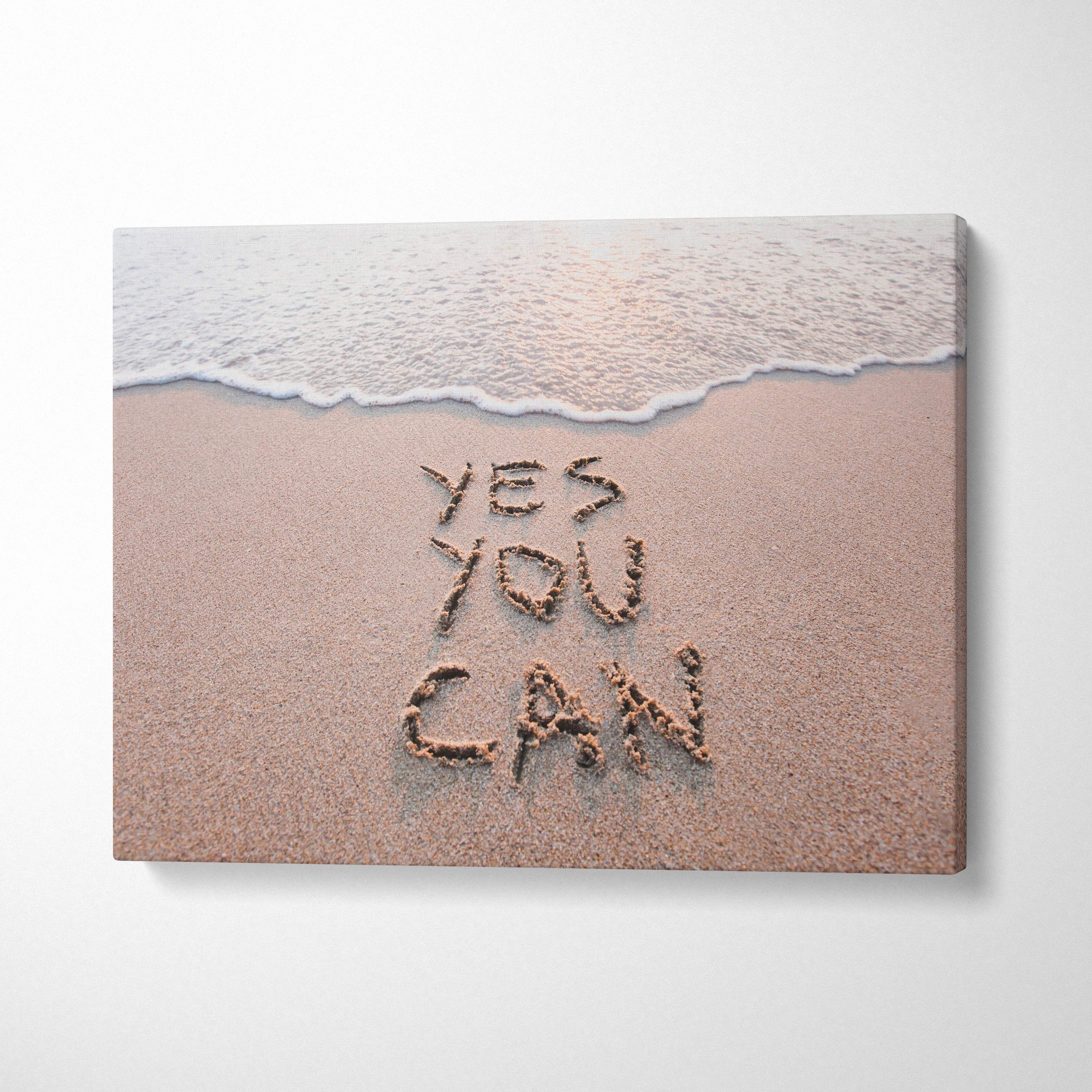 Beige canvas print with yes you can written in sand and a gentle wave for motivational beach wall art decor
