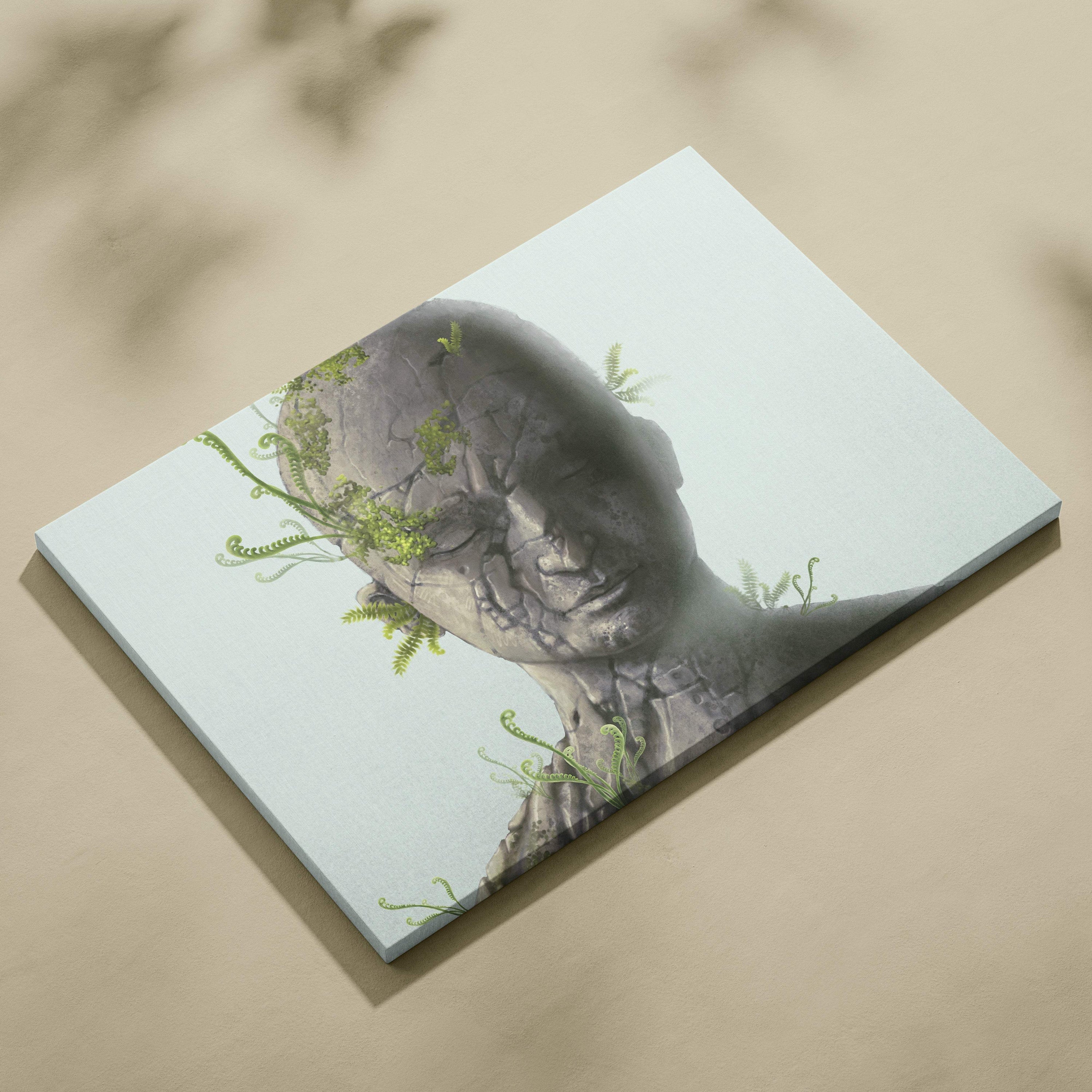 Gray stone bust canvas wall art with delicate green ferns growing on its surface for modern zen decor