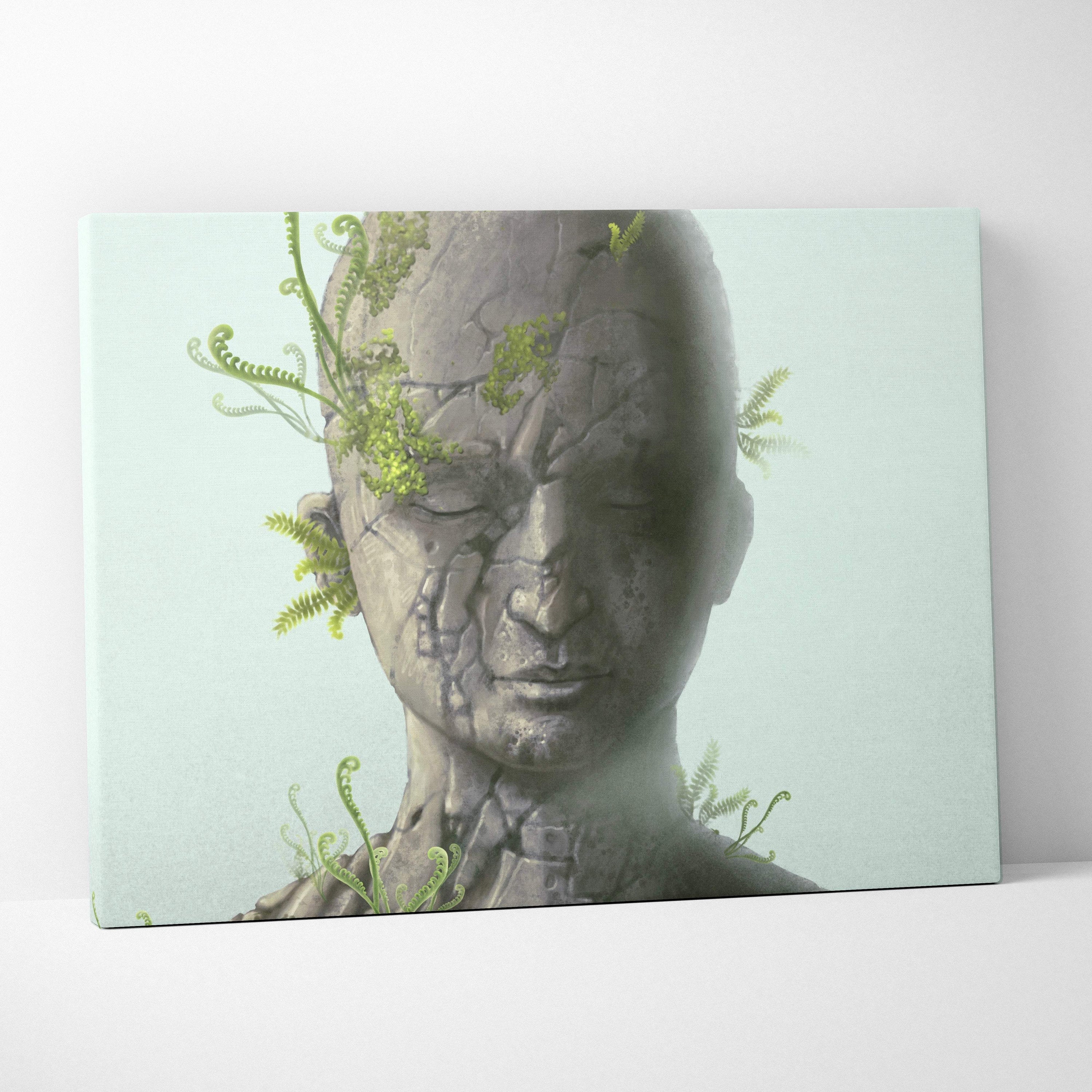 Contemporary cracked stone face canvas wall art featuring a gray stone sculpture with green ferns for modern zen decor