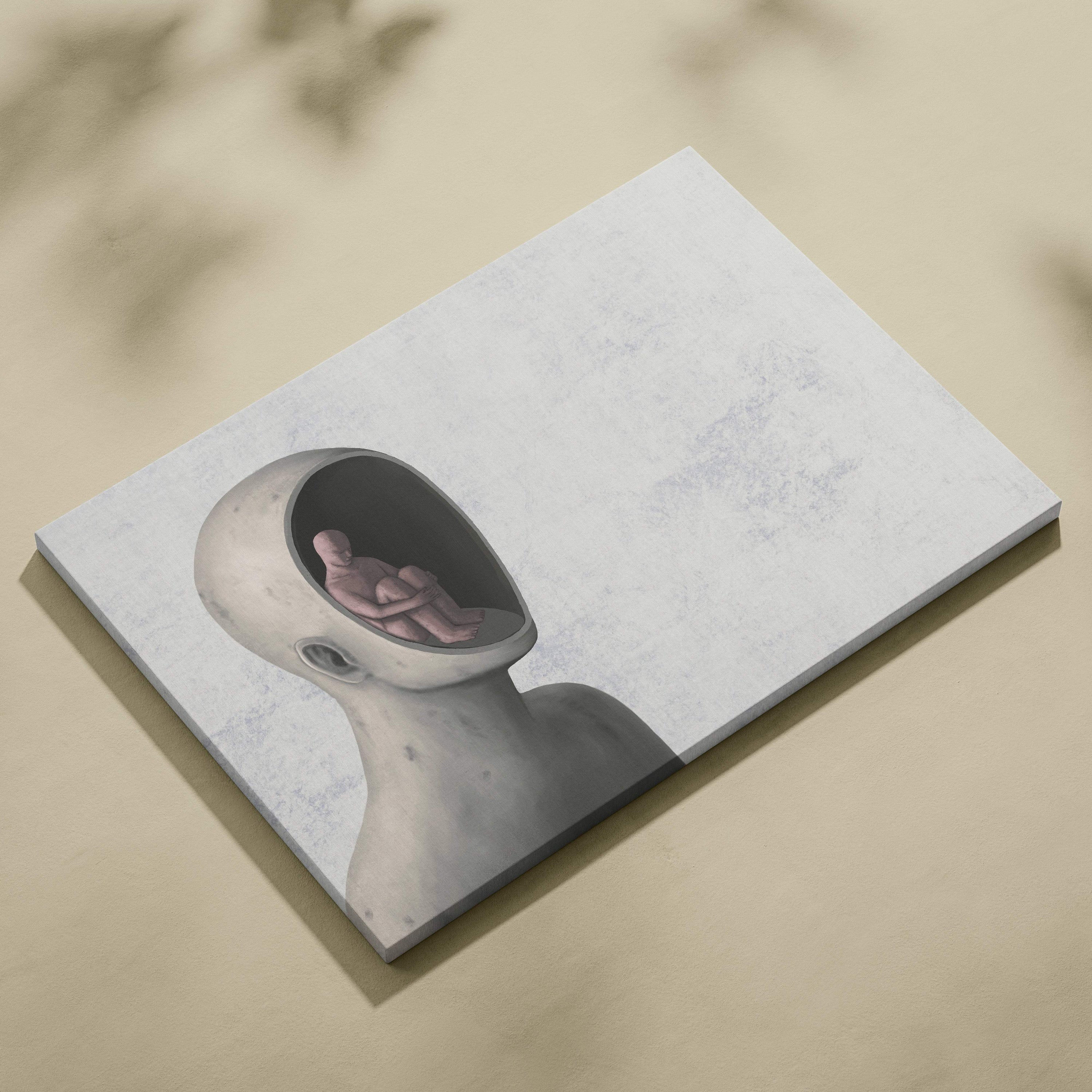 Contemporary minimalist canvas print featuring gray surreal humanoid head with seated figure inside for modern office decor