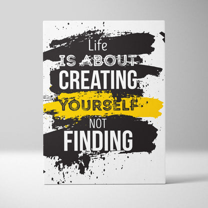 White canvas print with bold black and yellow brushstroke design featuring life is about creating yourself quote