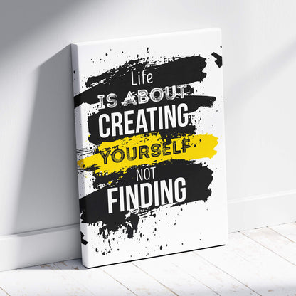 Black and yellow splatter canvas print with bold white life is about creating yourself motivational quote for home decor