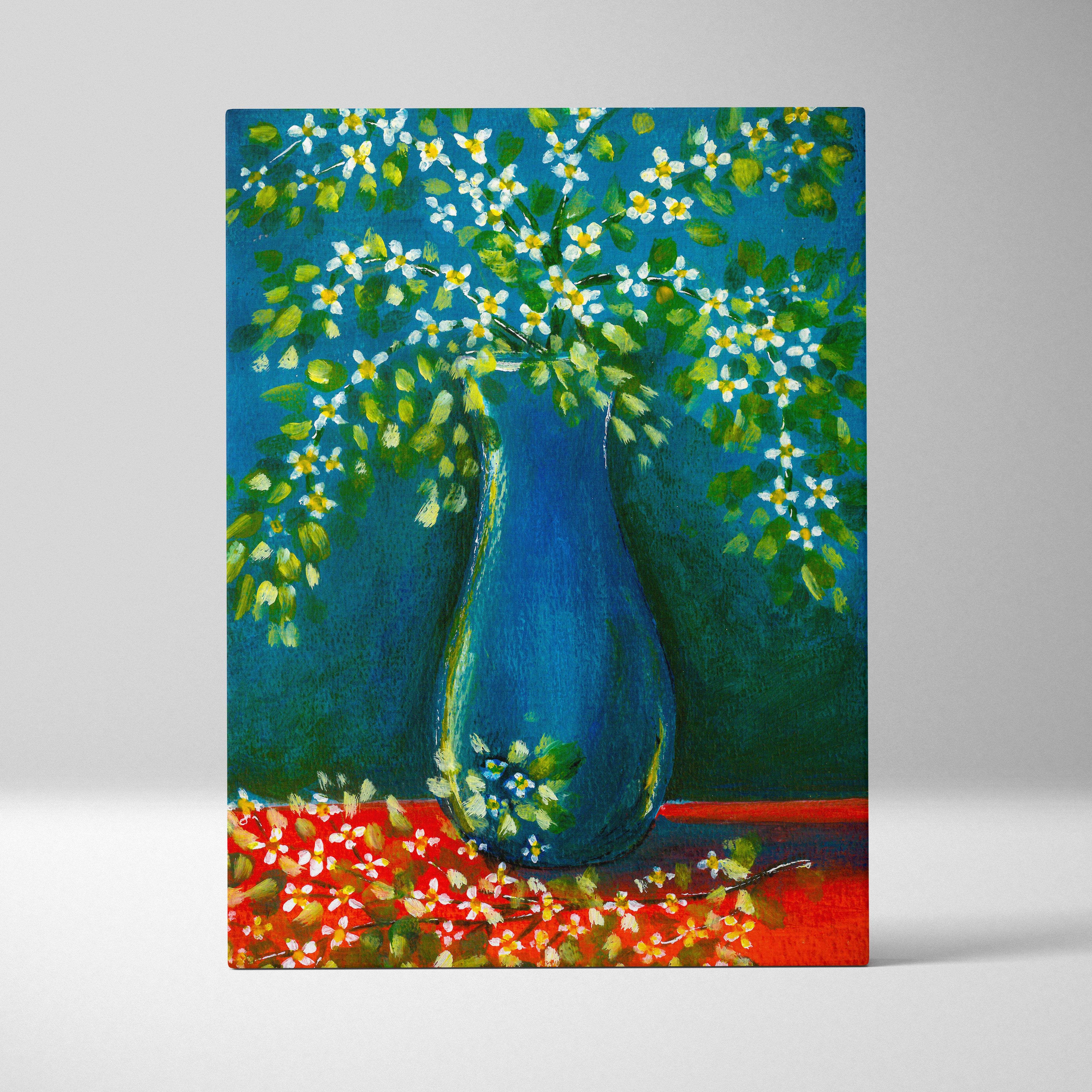A vibrant blue ceramic vase with white and yellow blossoms on a colorful folk art floral canvas print