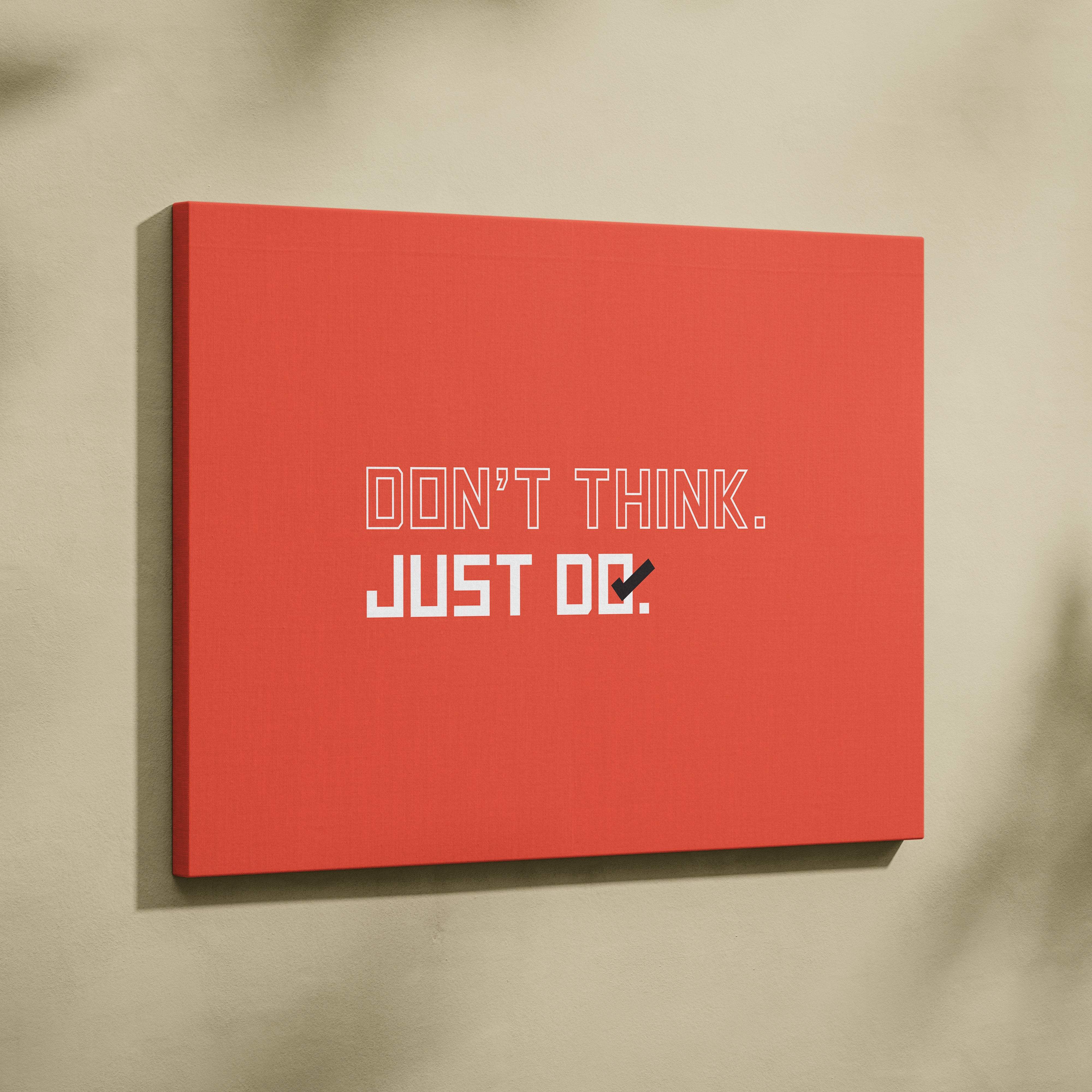 Red canvas wall art with bold orange motivational typography saying dont think just do for minimalist office decor
