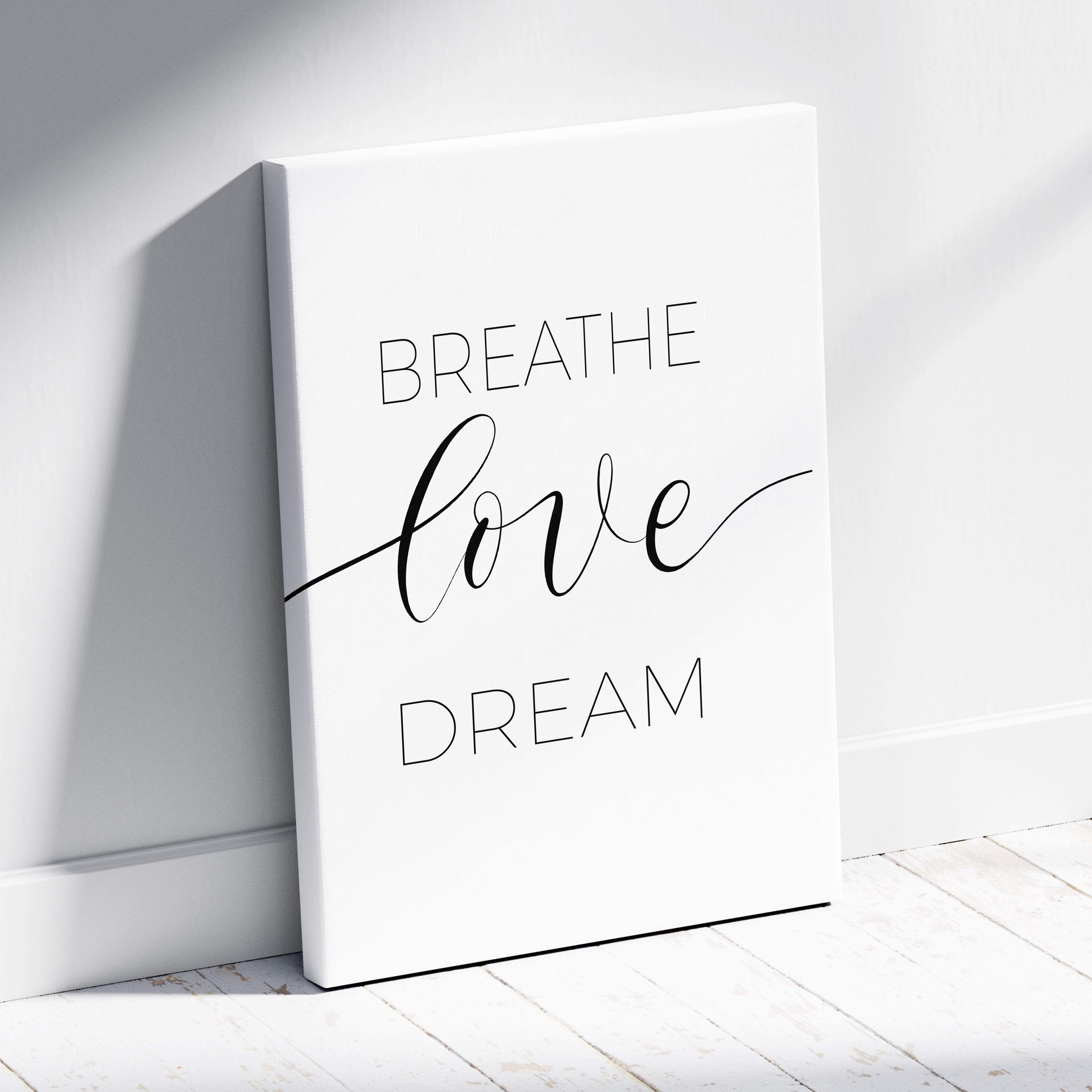 White canvas print with breathe love dream in elegant black script minimalist wall art for bedroom or office decor