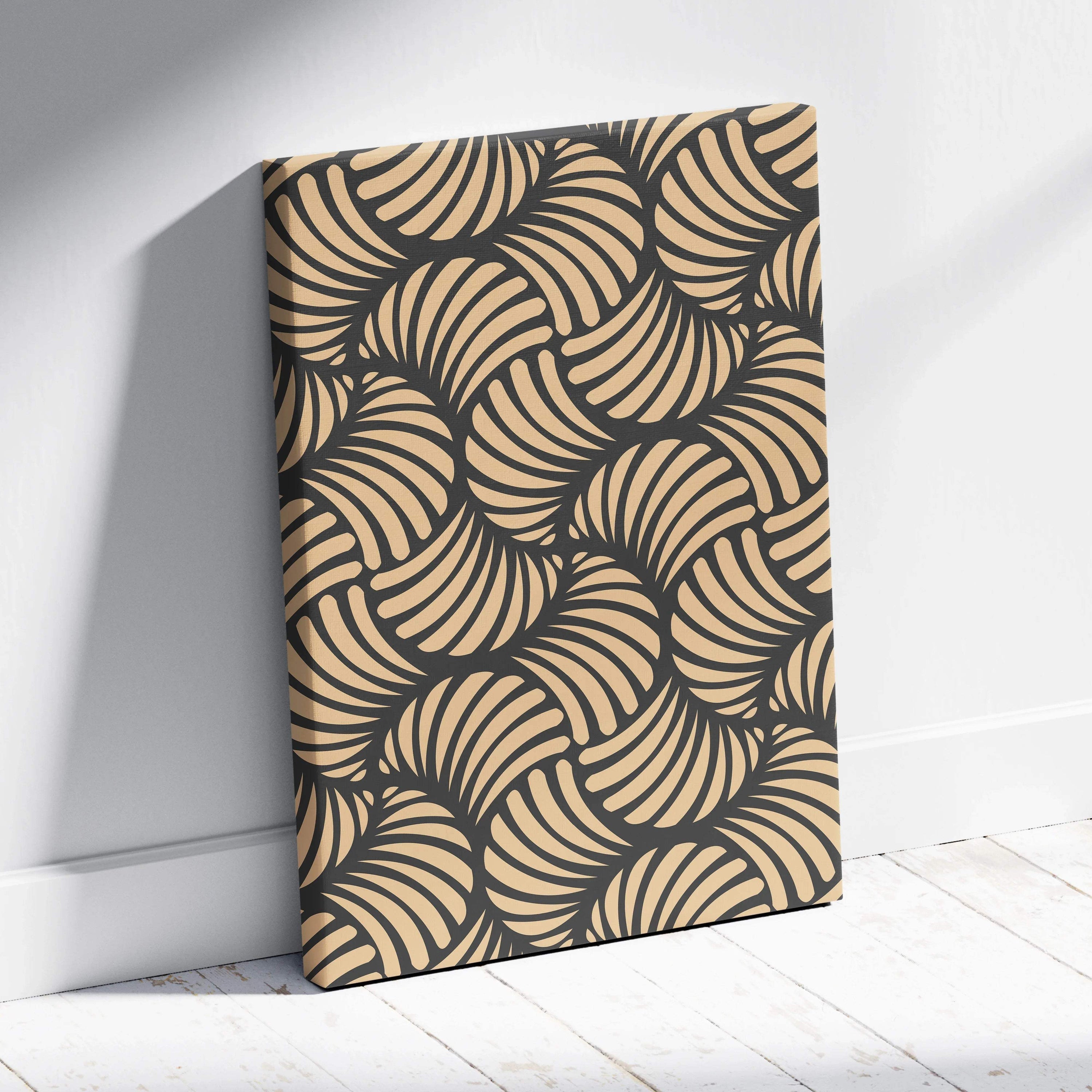 Beige and charcoal abstract leaf canvas art leaning on white wall