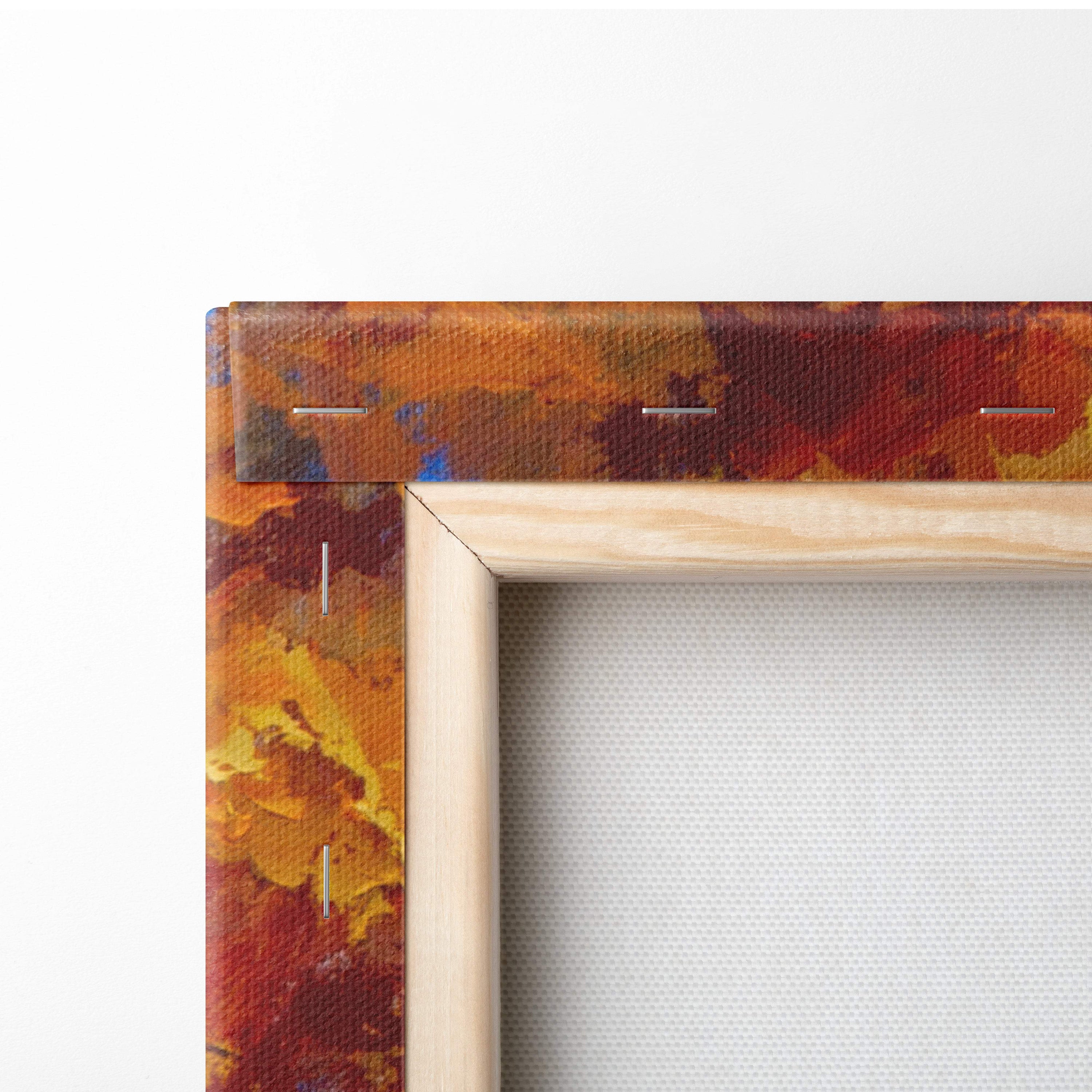 A wooden frame with vibrant autumnal orange red and yellow textured canvas print of golden fall foliage trees