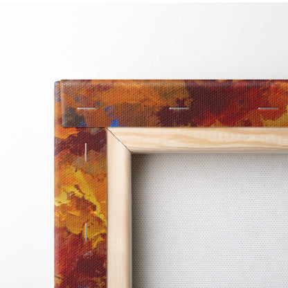 A wooden frame with vibrant autumnal orange red and yellow textured canvas print of golden fall foliage trees