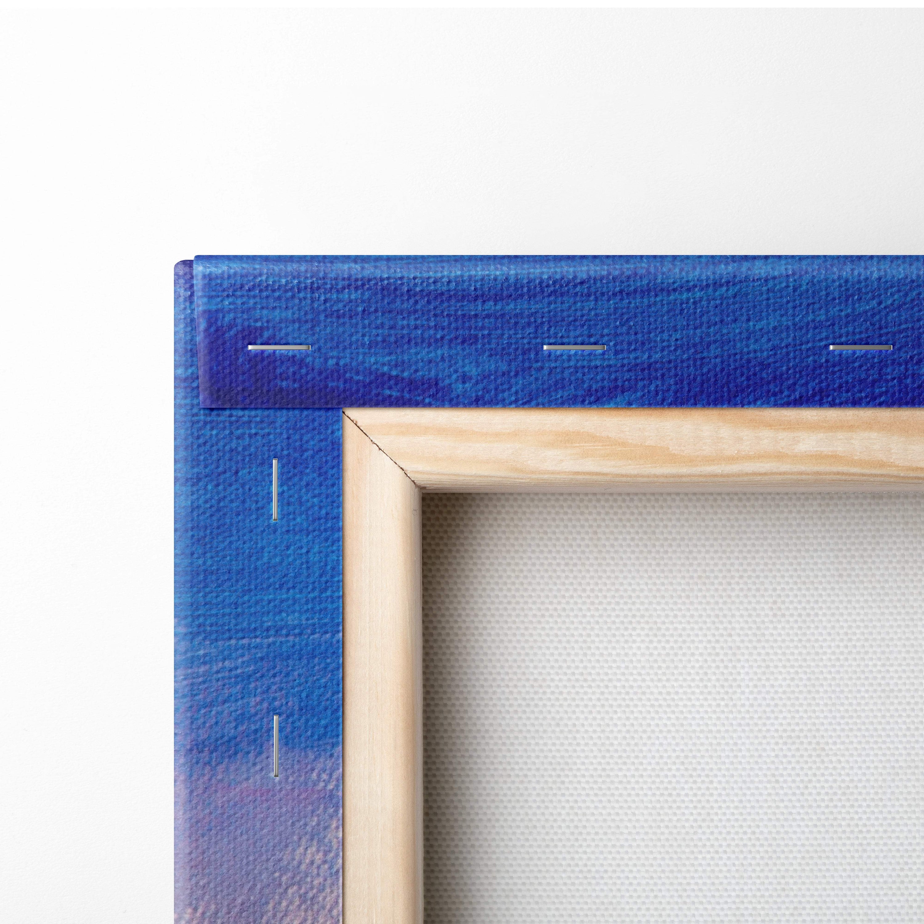 Blue gradient canvas wall art with visible stitching framed in light wood mountain meadow landscape painting