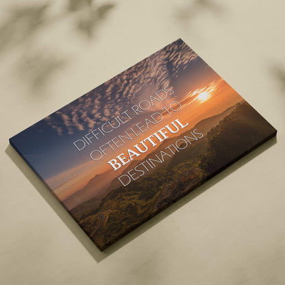 Motivational mountain sunset canvas wall art featuring a scenic orange sunset over mountains with an inspirational quote in white lettering