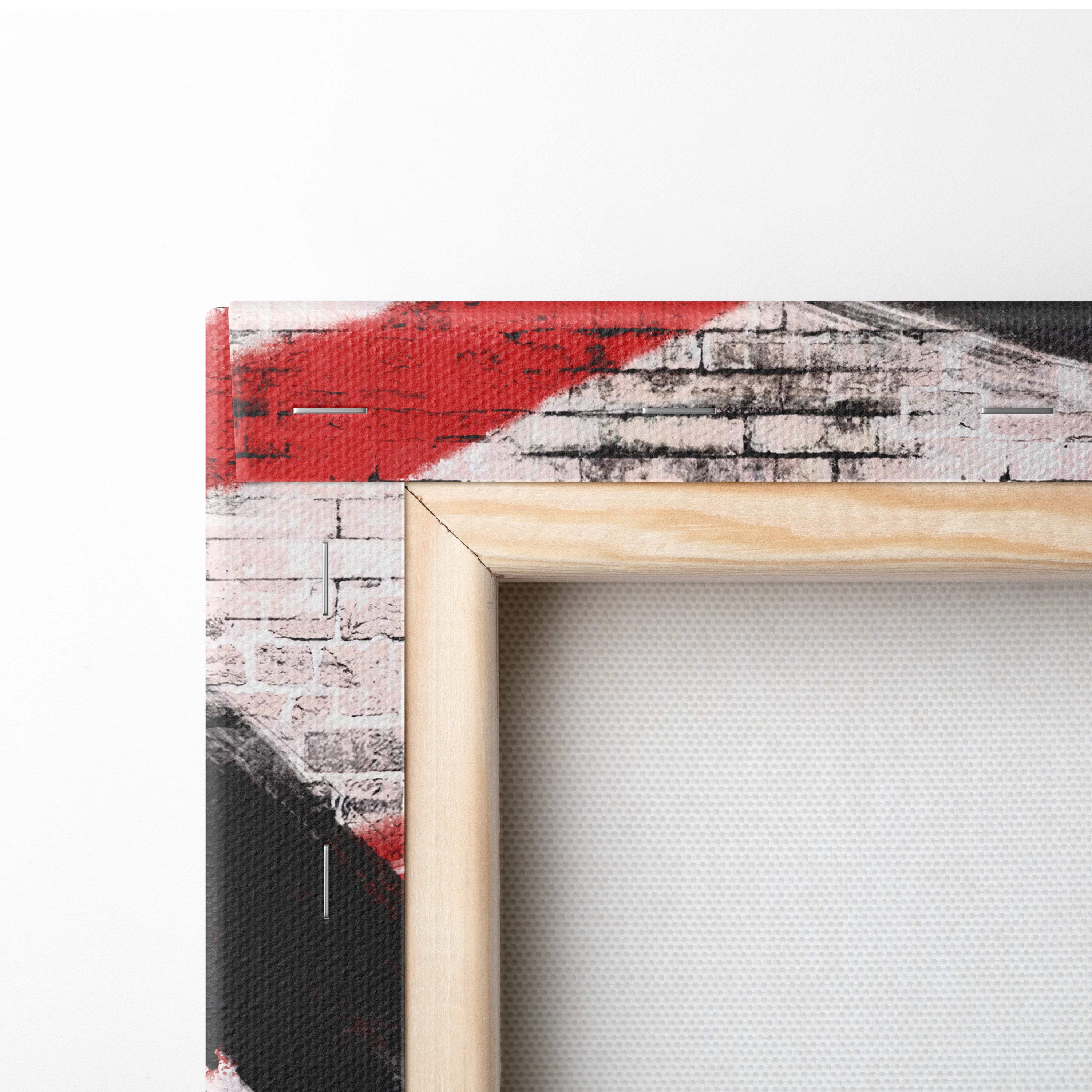 Light-colored wooden frame holding urban samurai graffiti canvas print with red black white brick wall design