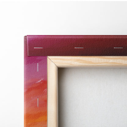 Fiery sunset dancer canvas wall art print with vibrant red to orange gradient, light wood frame, and stitched edges