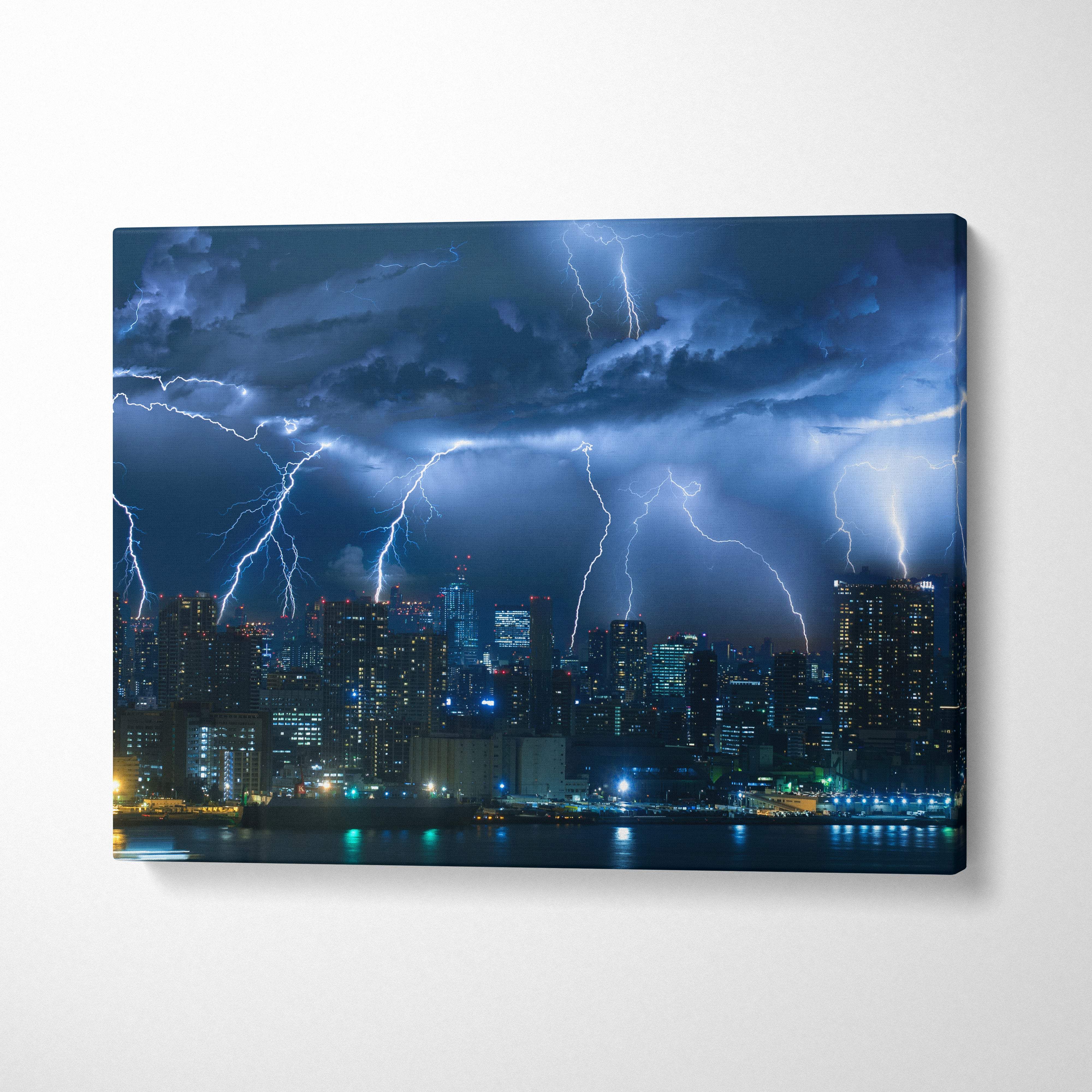 Canvas print of a city skyline at night with electric blue lightning bolts illuminating dramatic storm clouds and buildings