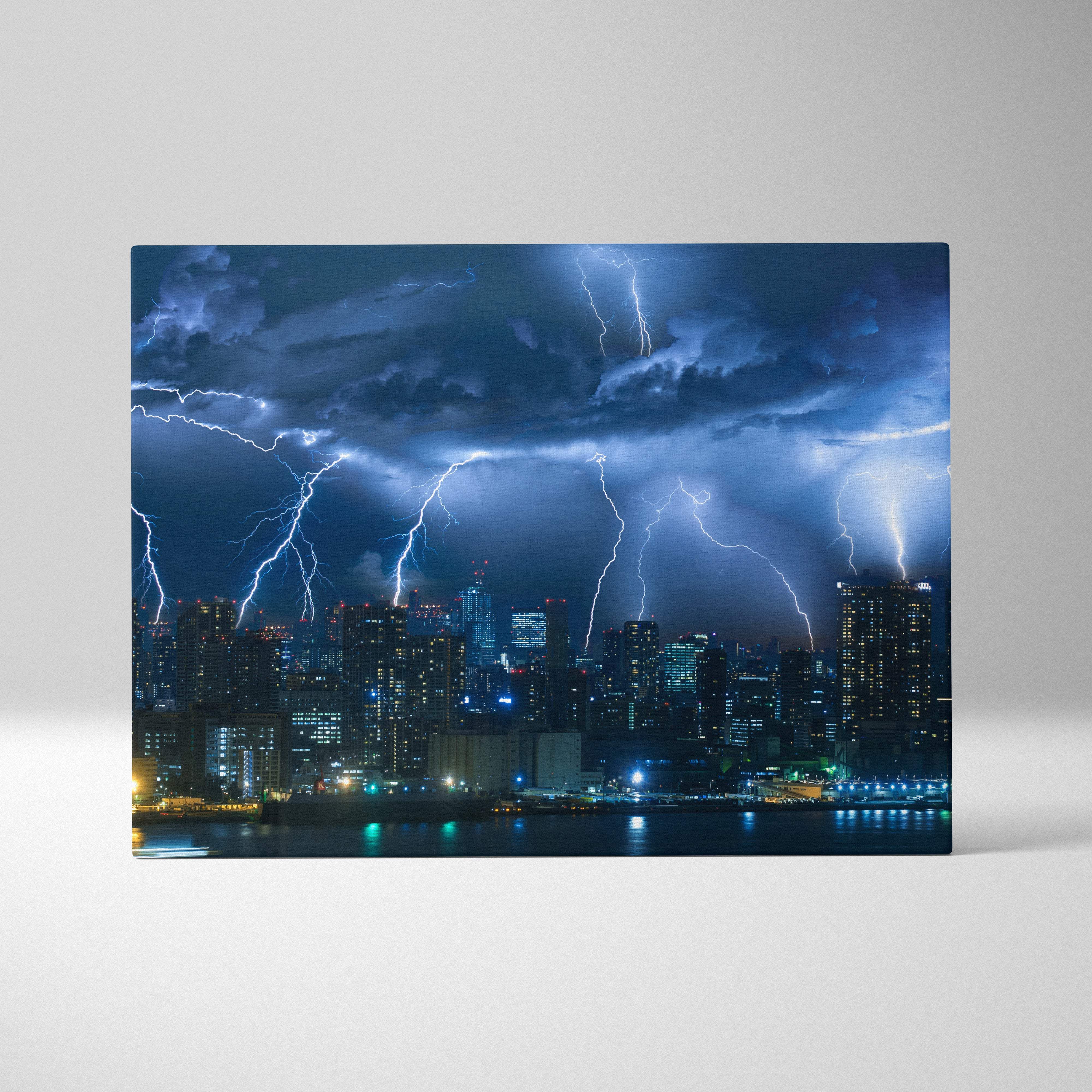 A rectangular canvas print of a dramatic city skyline at night with electric blue lightning strikes under stormy sky